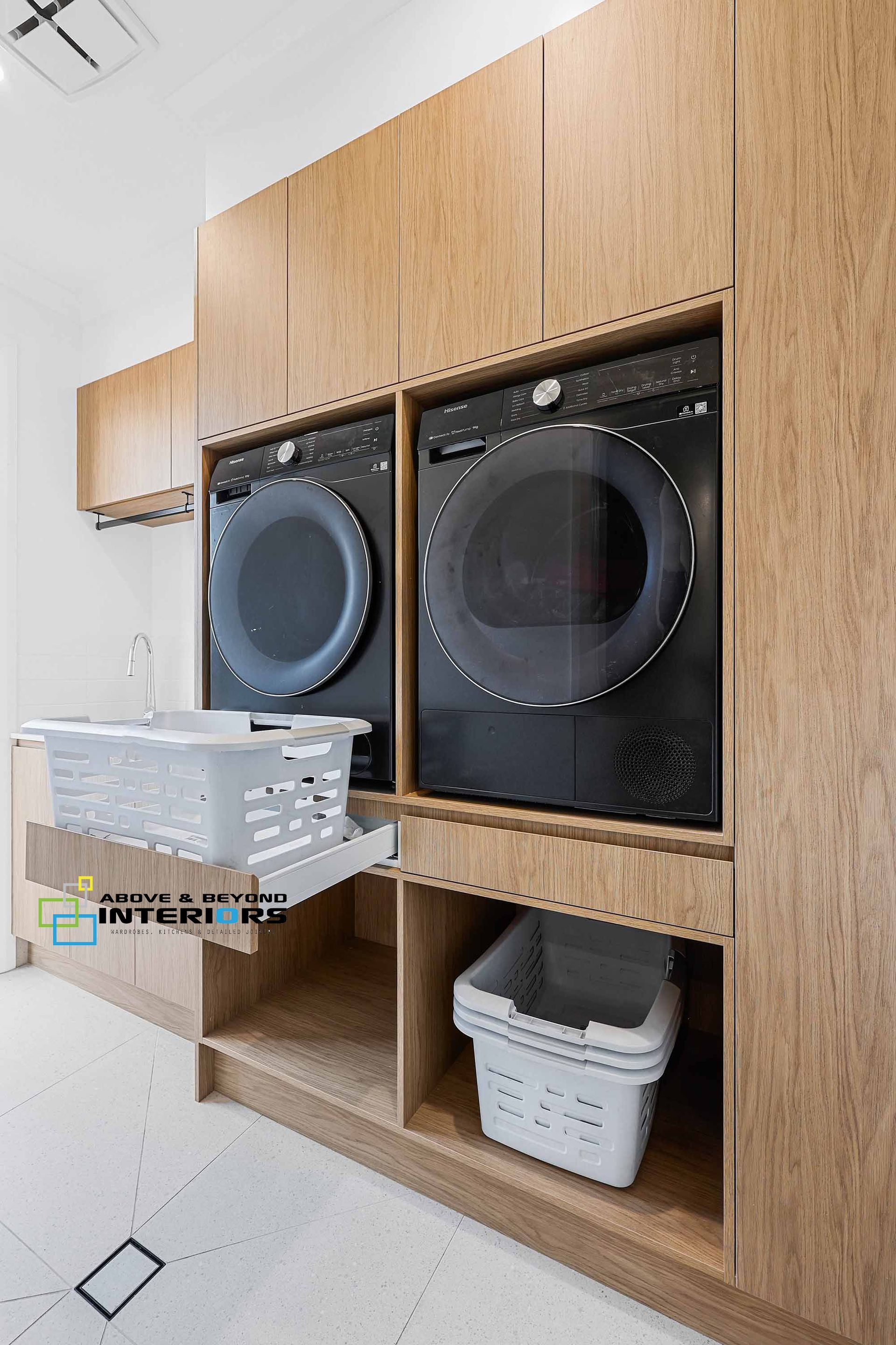 Laundry Room with Stacked Washer and Dryer — Above & Beyond Interiors in Smeaton Grange, NSW
