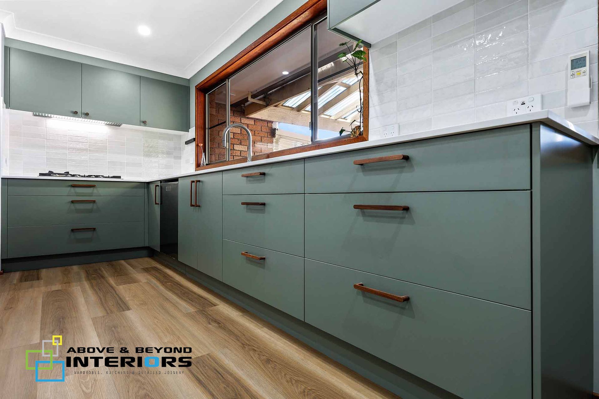 Modern Kitchen with Wood Flooring, and A Large Pass-Through Window — Above & Beyond Interiors in Smeaton Grange, NSW