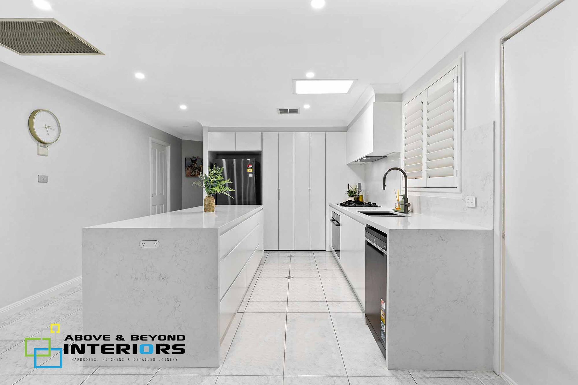 A White Kitchen with Island — Above & Beyond Interiors in Smeaton Grange, NSW