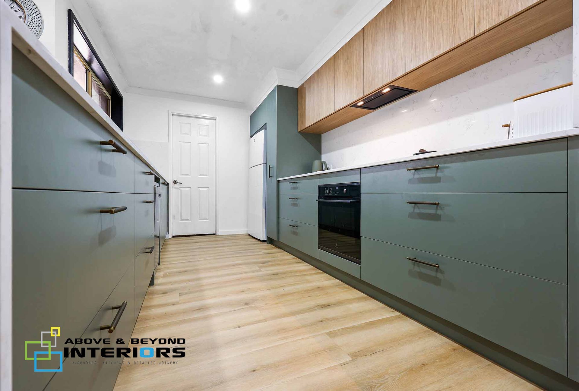 A Kitchen with Wood Floors — Above & Beyond Interiors in Smeaton Grange, NSW
