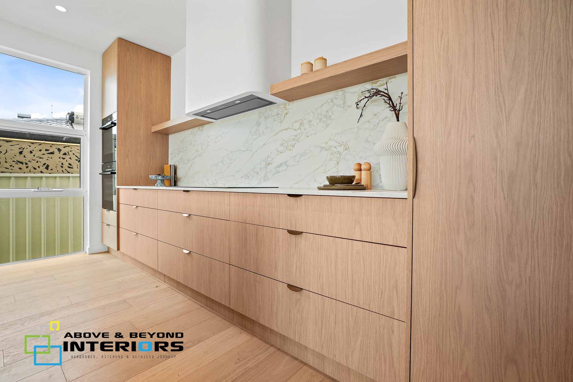 Modern Minimalist Kitchen with Light Countertops, and Marble Backsplash — Above & Beyond Interiors in Smeaton Grange, NSW