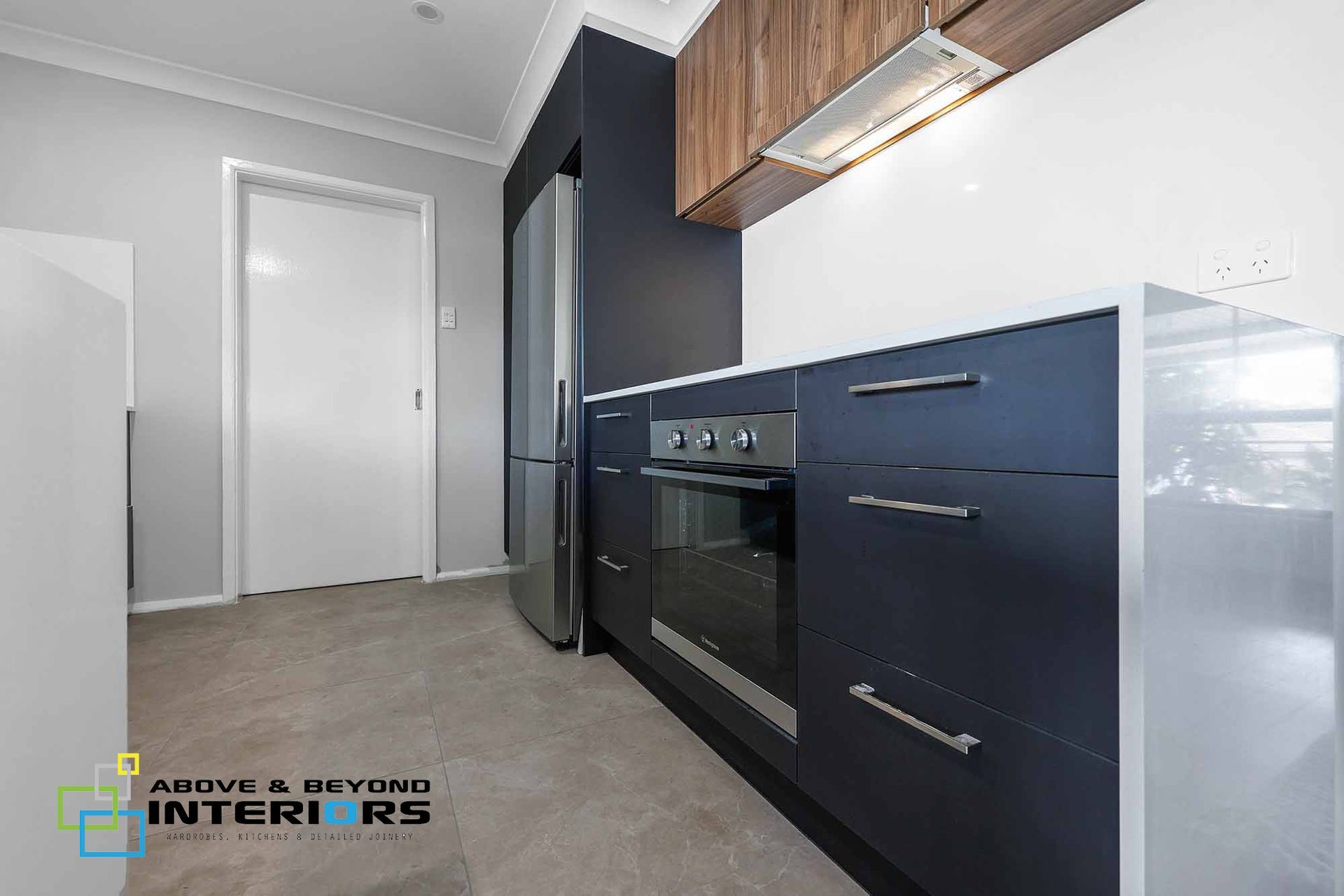 Modern Kitchen with Navy Cabinets — Above & Beyond Interiors in Smeaton Grange, NSW