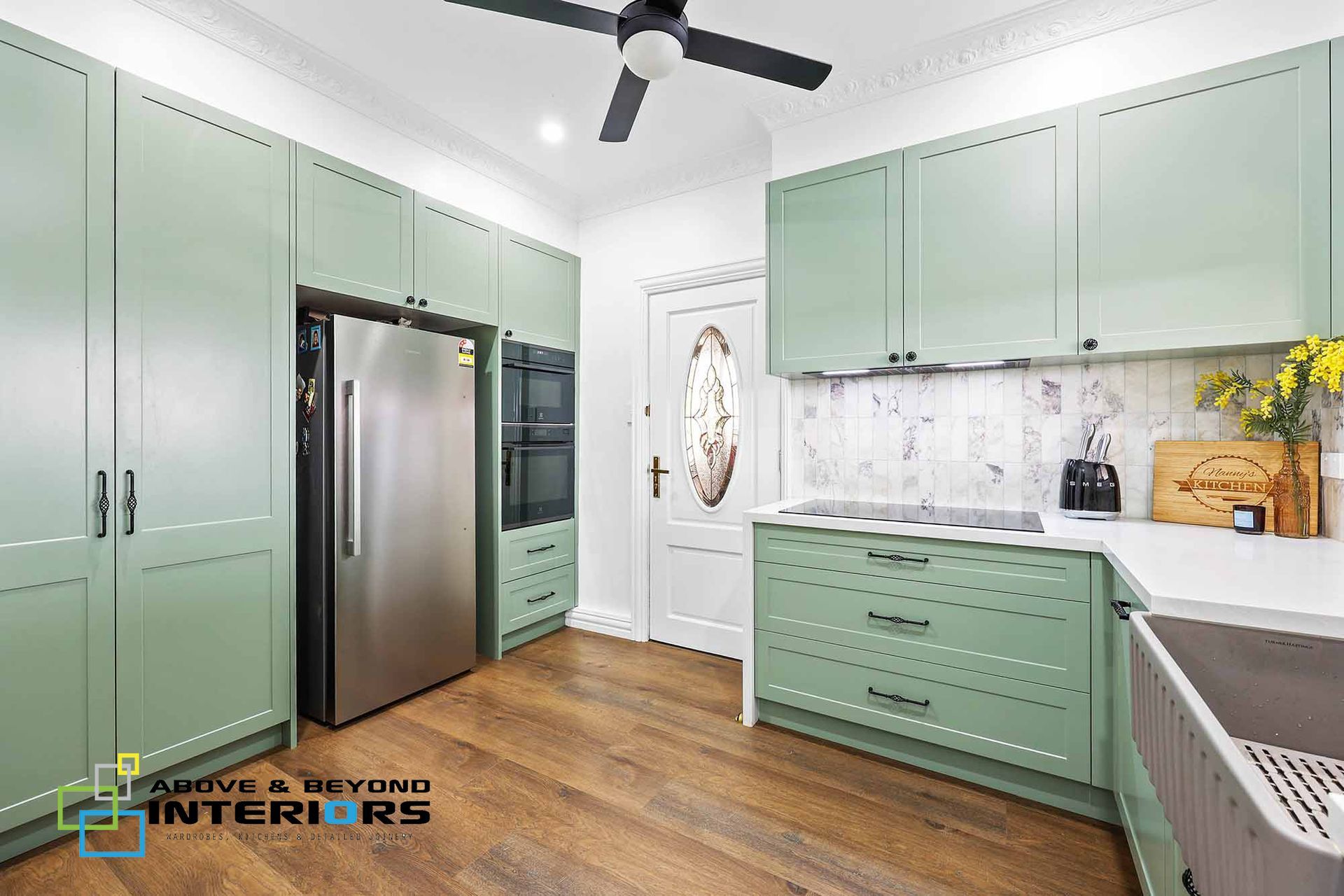 Bright Mint-Green Kitchen with Stainless Steel Fridge — Above & Beyond Interiors in Smeaton Grange, NSW