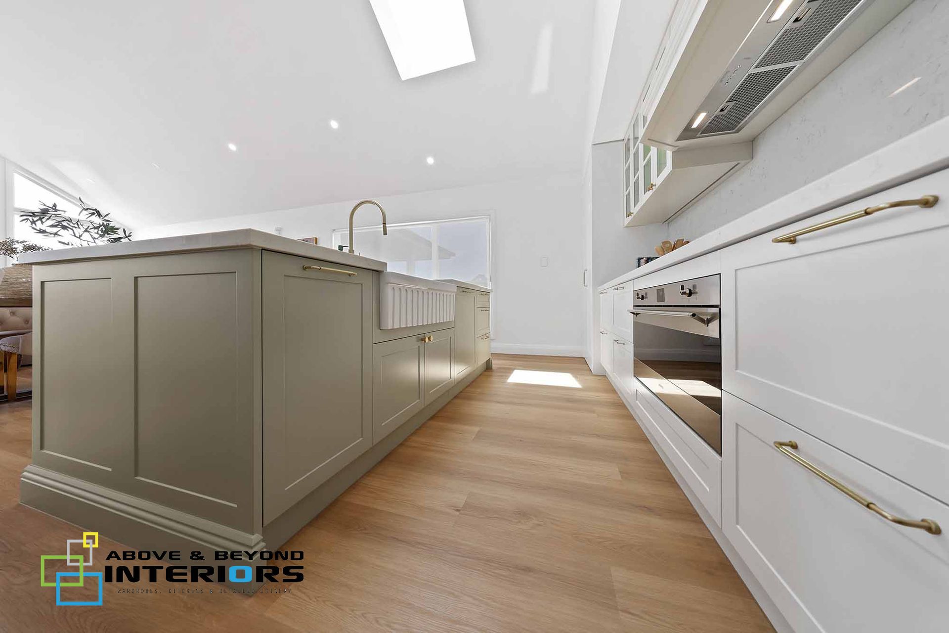 Modern White Kitchen with Gray Island and Built-In Appliances — Above & Beyond Interiors in Smeaton Grange, NSW