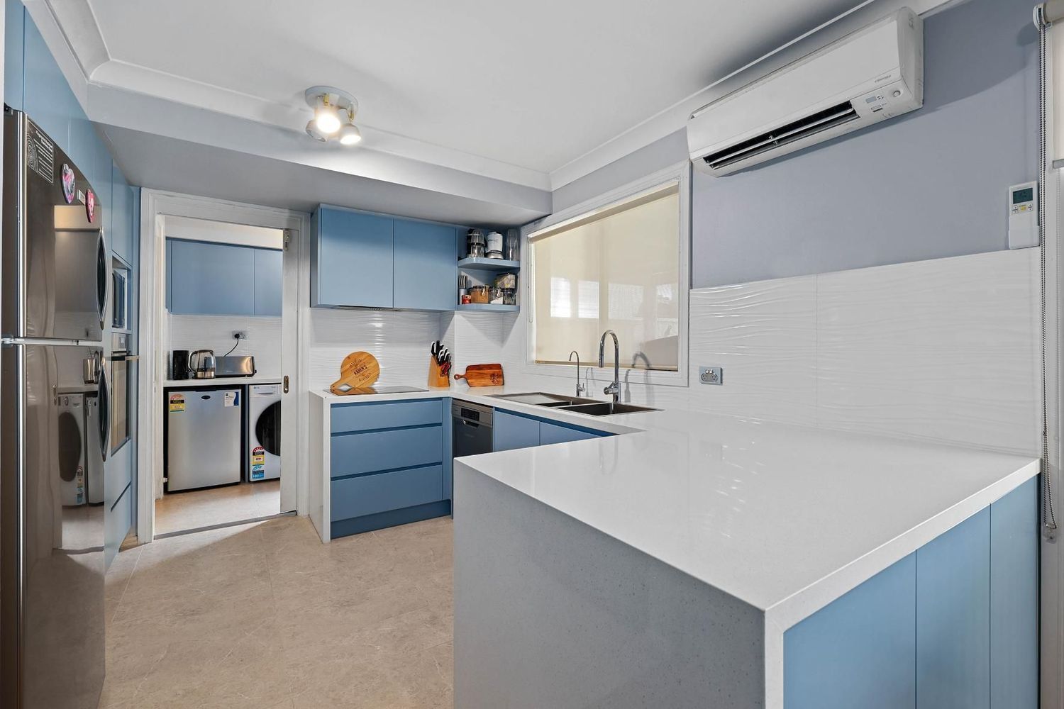 Bright Modern Kitchen With Blue Cabinets — Above & Beyond Interiors in Smeaton Grange, NSW