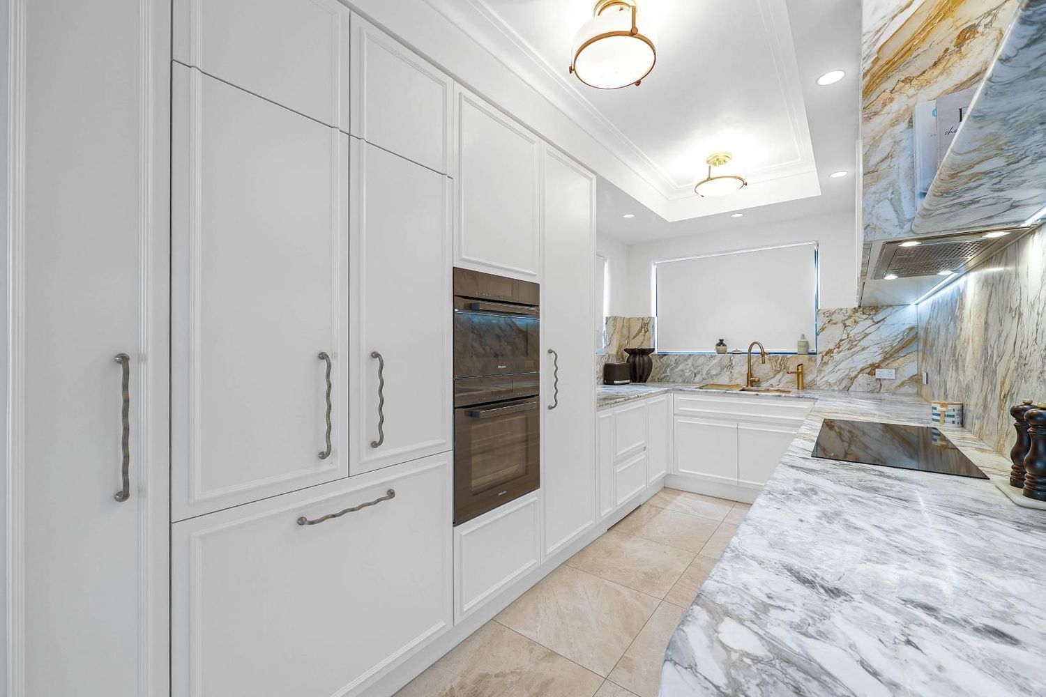 Bright White Modern Kitchen With Built-in Ovens — Above & Beyond Interiors in Smeaton Grange, NSW