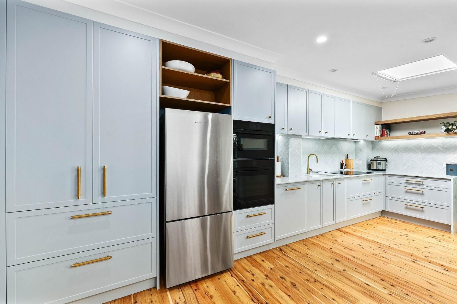 Bright Modern Kitchen With Light Blue Cabinets — Above & Beyond Interiors in Smeaton Grange, NSW