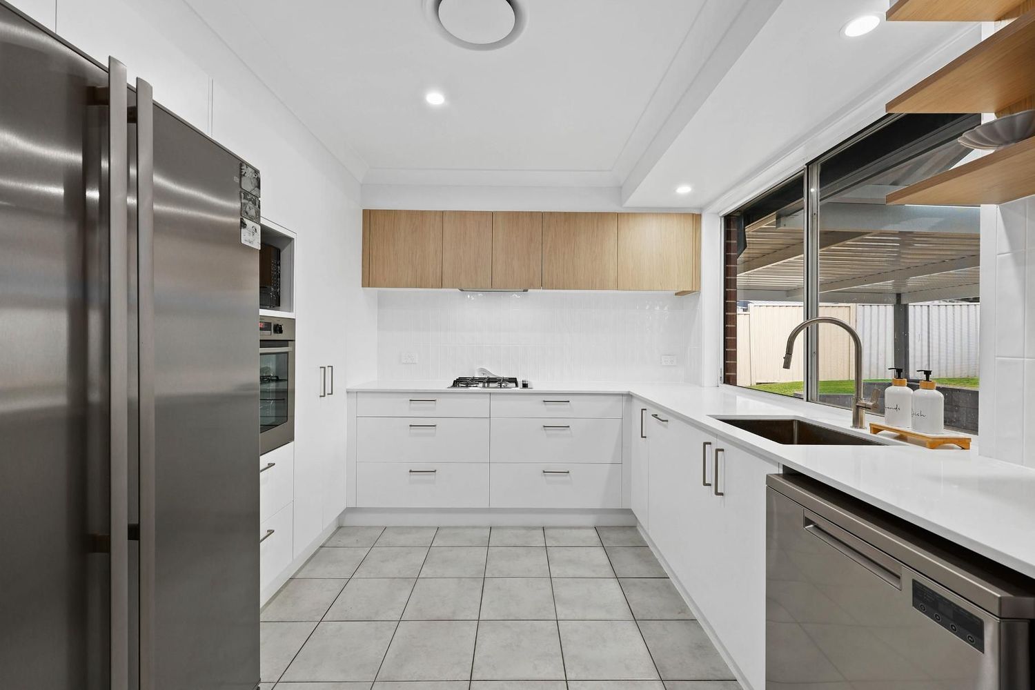Bright Modern Kitchen With White Cabinets — Above & Beyond Interiors in Smeaton Grange, NSW