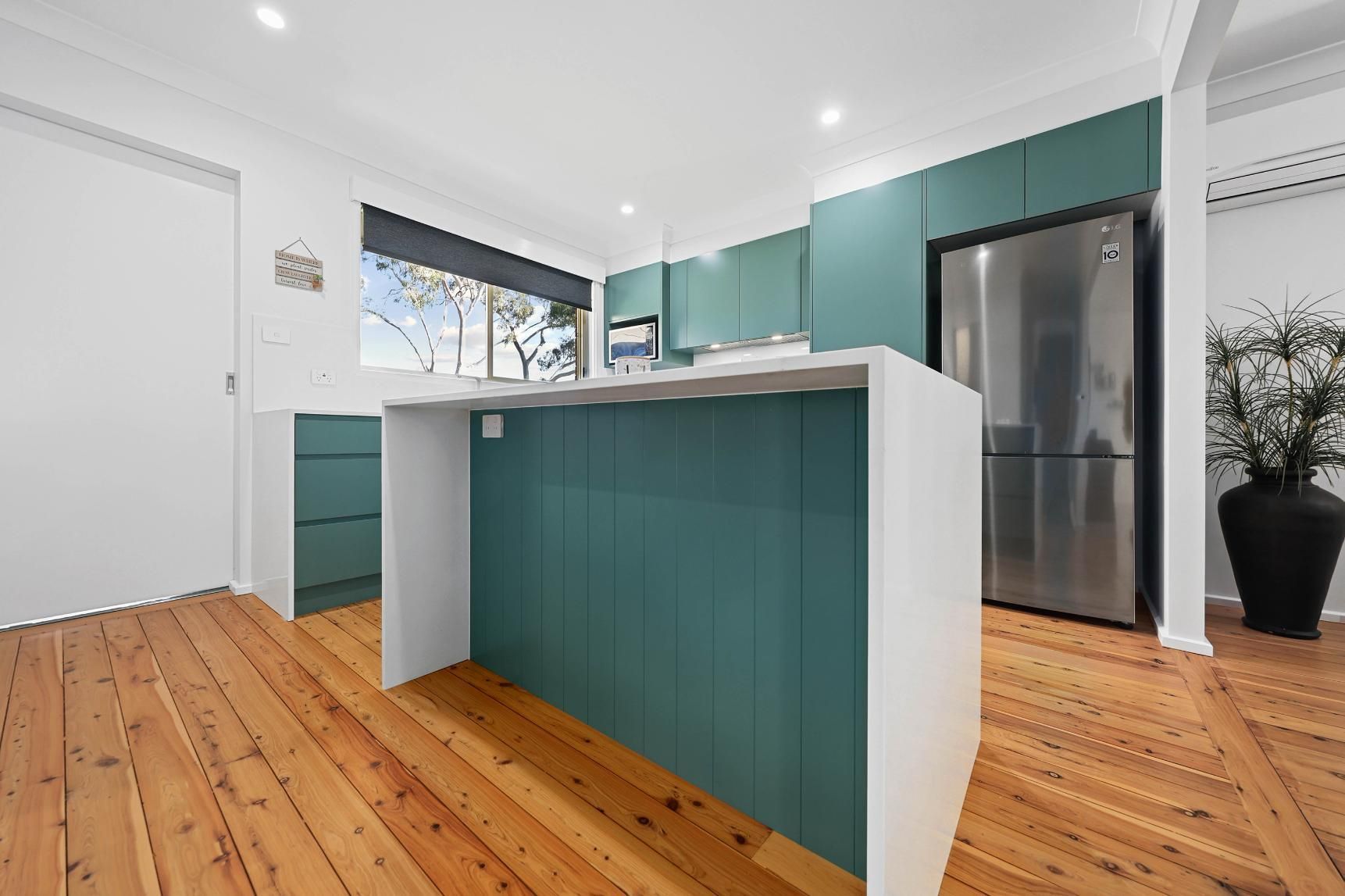 Bright Kitchen With Teal Island — Above & Beyond Interiors in Smeaton Grange, NSW
