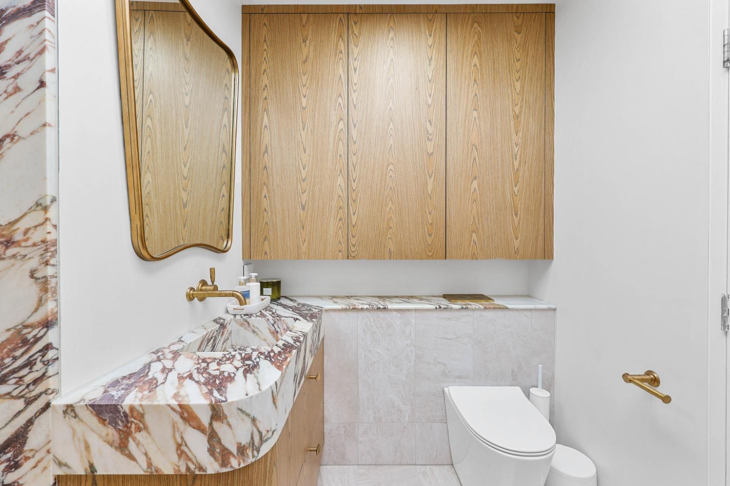 Small Bathroom With Gold Cabinets, Marble Sink — Above & Beyond Interiors in Smeaton Grange, NSW