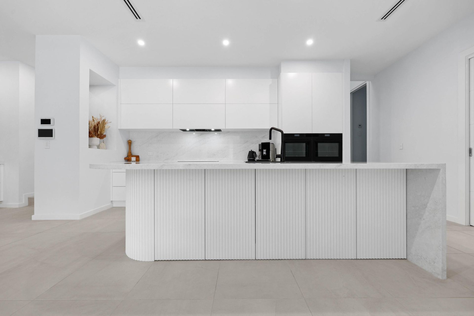 Modern White Kitchen With Large Island — Above & Beyond Interiors in Smeaton Grange, NSW