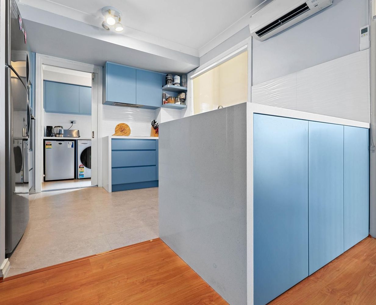 Small Modern Room With Blue Cabinets — Above & Beyond Interiors in Smeaton Grange, NSW