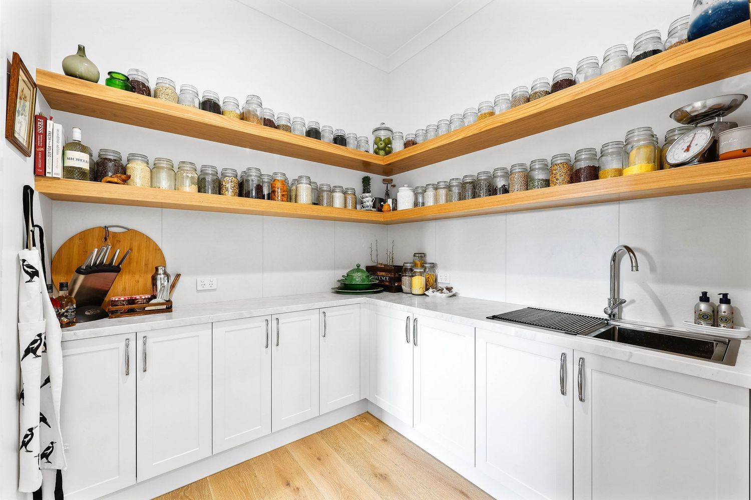 Bright White Kitchen With Wraparound Wooden Shelves — Above & Beyond Interiors in Smeaton Grange, NSW
