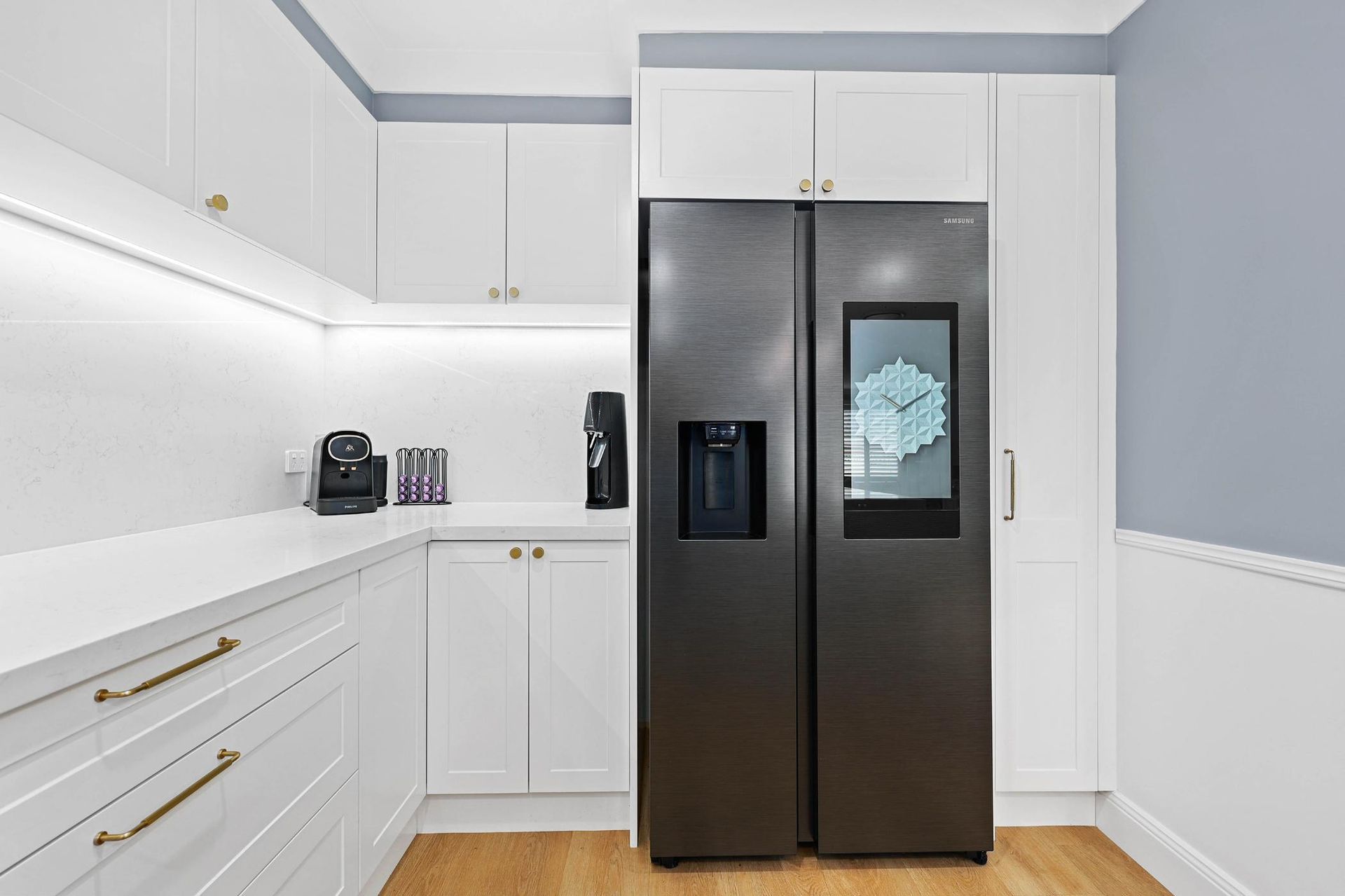 Bright White Kitchen With Black Double-door Refrigerator — Above & Beyond Interiors in Smeaton Grange, NSW