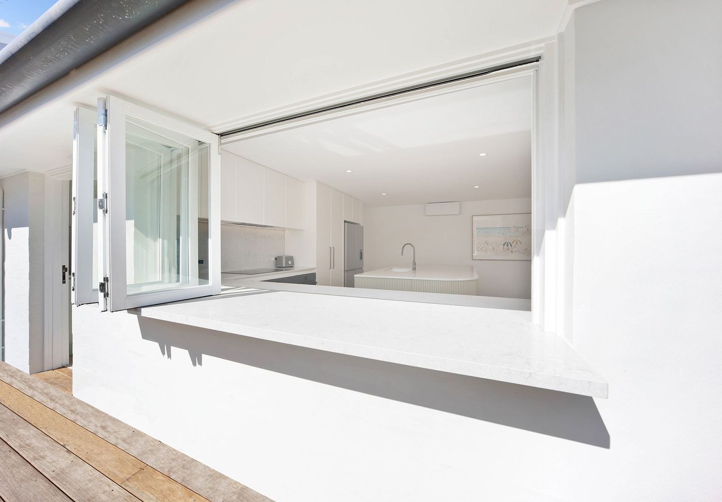 Bright Modern Kitchen With a Large Open Serving Window — Above & Beyond Interiors in Smeaton Grange, NSW
