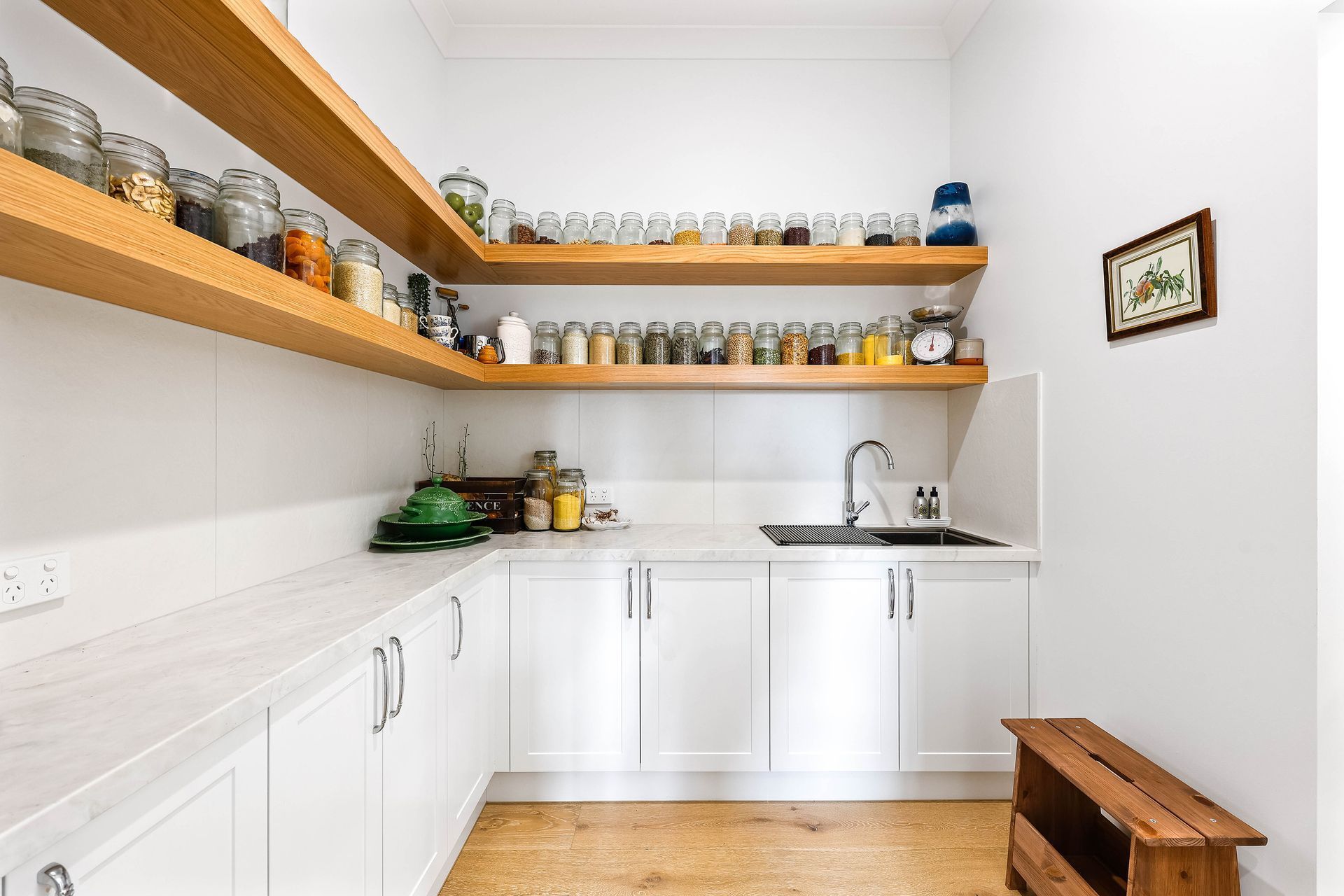 Bright White Kitchen With Open Wooden Shelves — Above & Beyond Interiors in Smeaton Grange, NSW