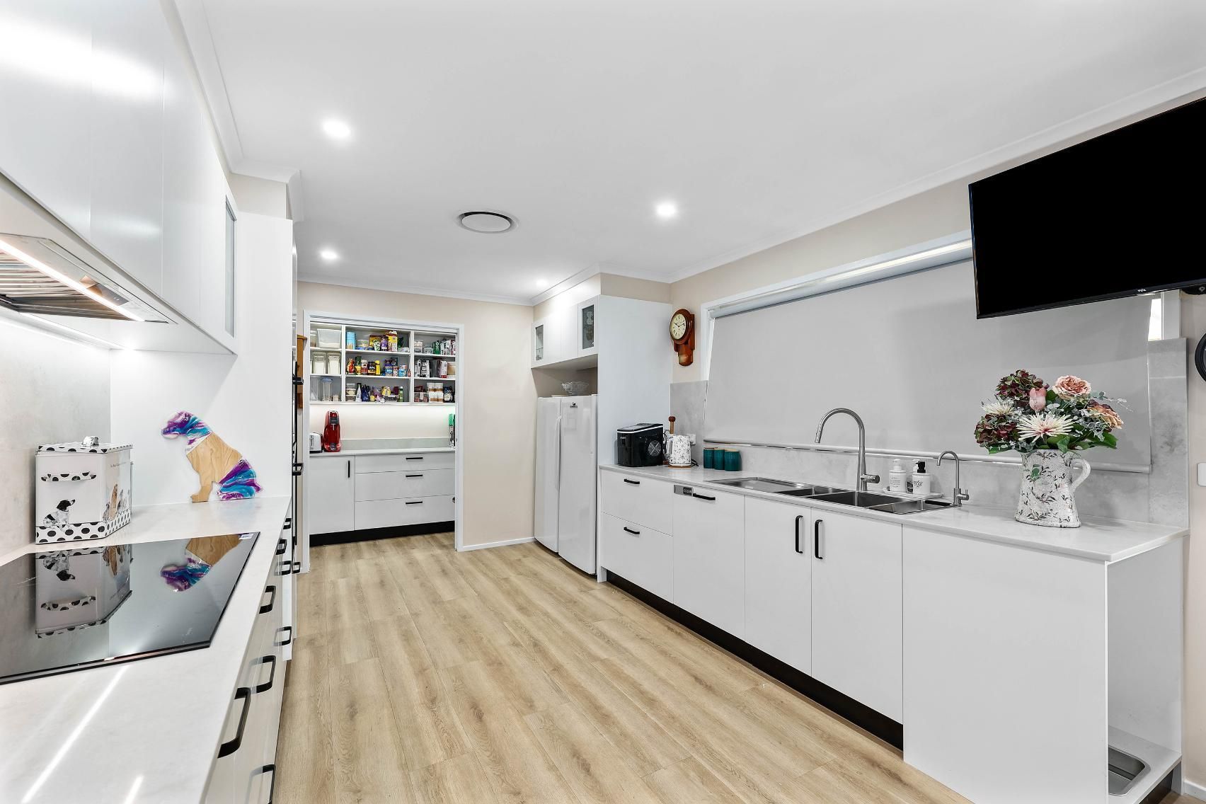 Bright Modern Kitchen With White Cabinets — Above & Beyond Interiors in Smeaton Grange, NSW