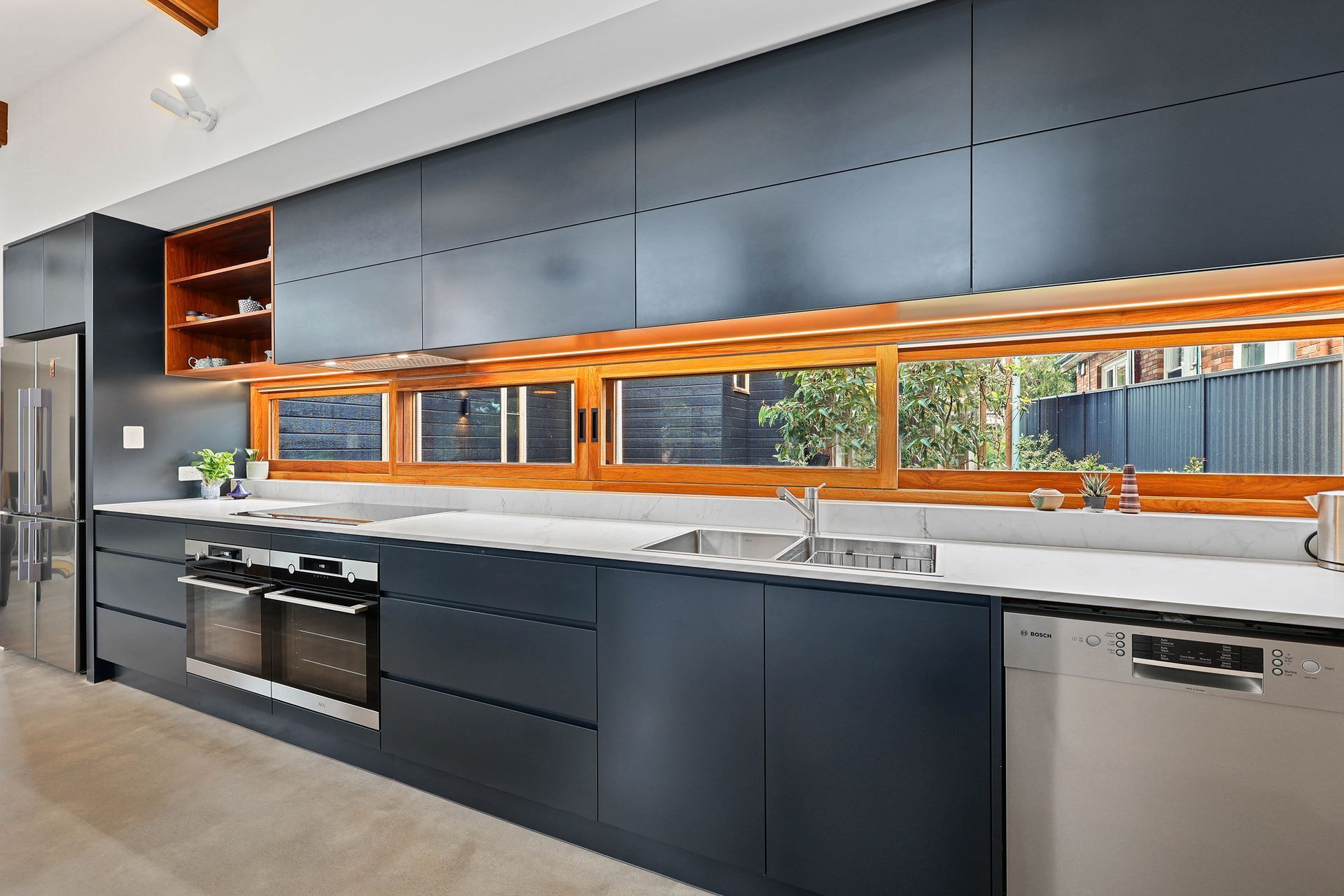 Modern Kitchen With Dark Cabinets, Stainless Appliances — Above & Beyond Interiors in Smeaton Grange, NSW