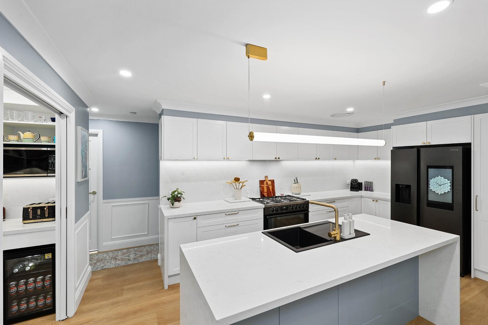 Bright Modern Kitchen With White Cabinets — Above & Beyond Interiors in Smeaton Grange, NSW