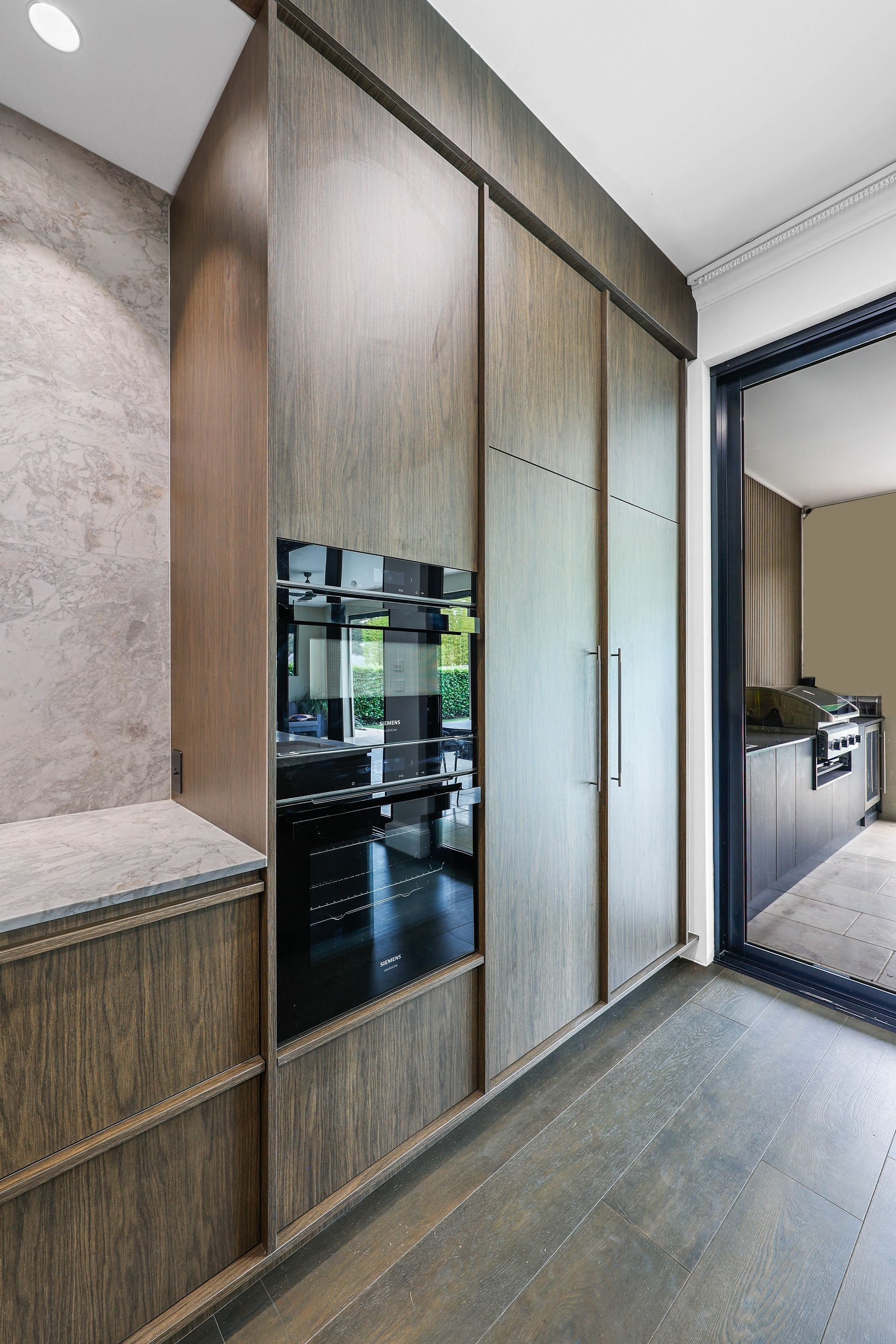 Modern Kitchen Hallway With Wood Cabinetry — Above & Beyond Interiors in Smeaton Grange, NSW