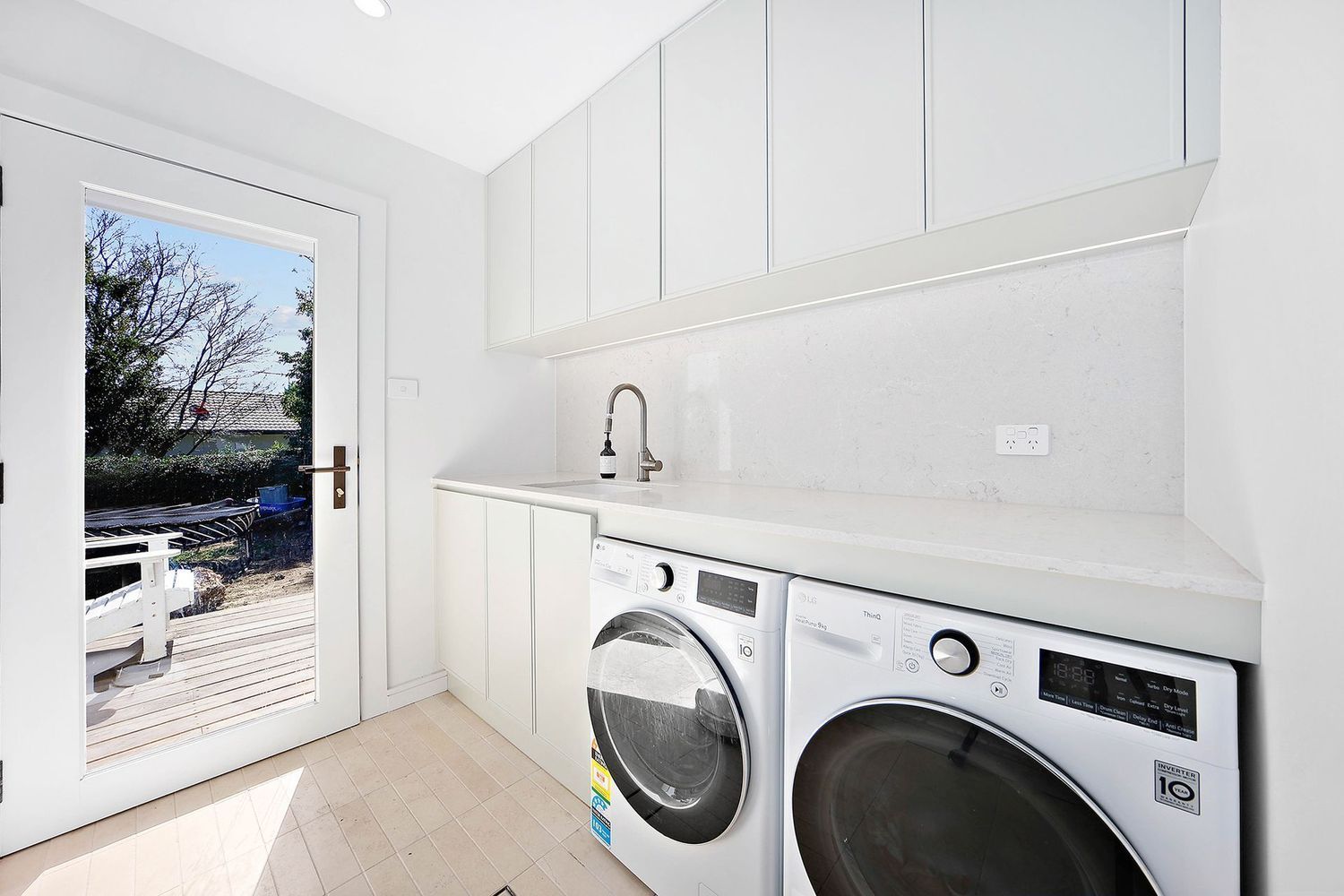 Bright Laundry Room With White Cabinets — Above & Beyond Interiors in Smeaton Grange, NSW