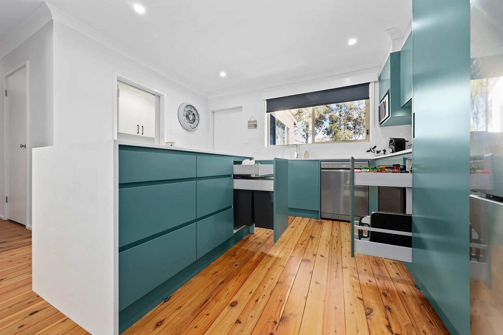 Modern Kitchen With Teal Cabinets, Wood Floors — Above & Beyond Interiors in Smeaton Grange, NSW