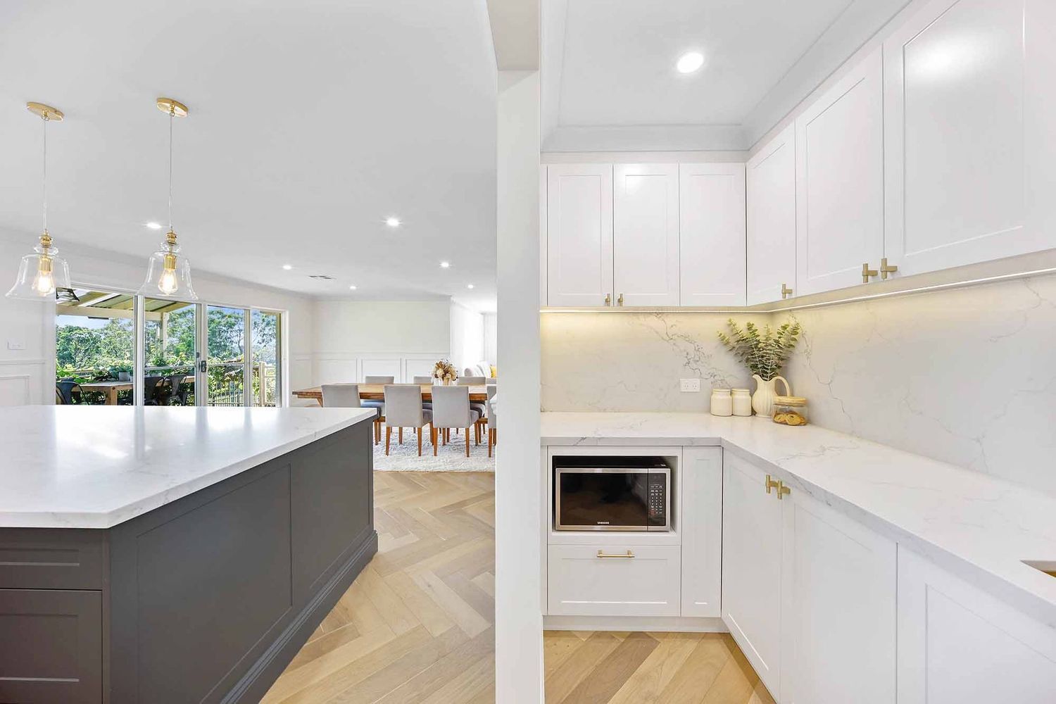 Bright Modern White Kitchen With Island — Above & Beyond Interiors in Smeaton Grange, NSW