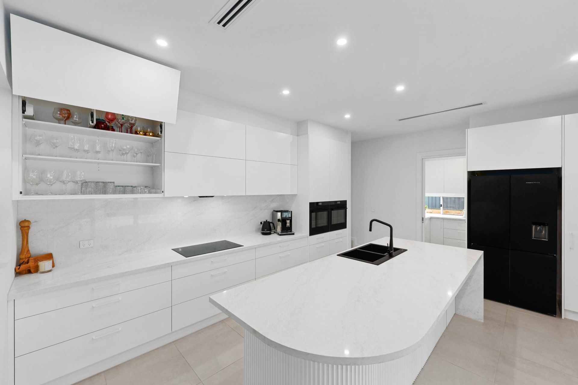 Modern White Kitchen With Island, Black Appliances — Above & Beyond Interiors in Smeaton Grange, NSW