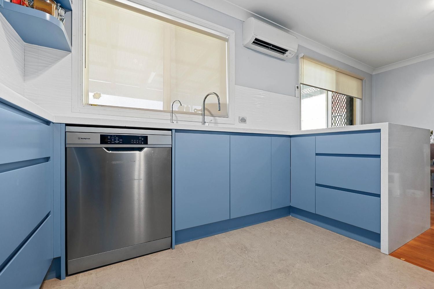Modern Kitchen With Blue Cabinets, Stainless Steel Dishwasher — Above & Beyond Interiors in Smeaton Grange, NSW