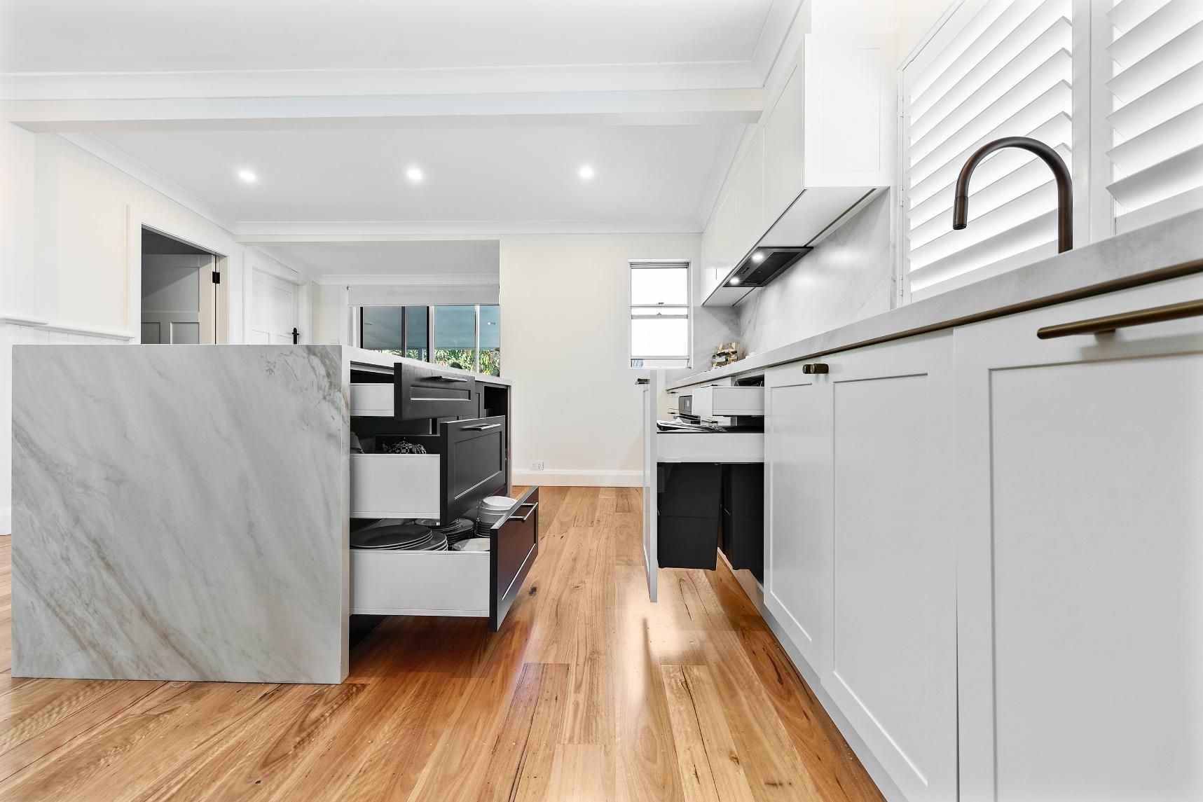 Bright Modern Kitchen With White Cabinets — Above & Beyond Interiors in Smeaton Grange, NSW