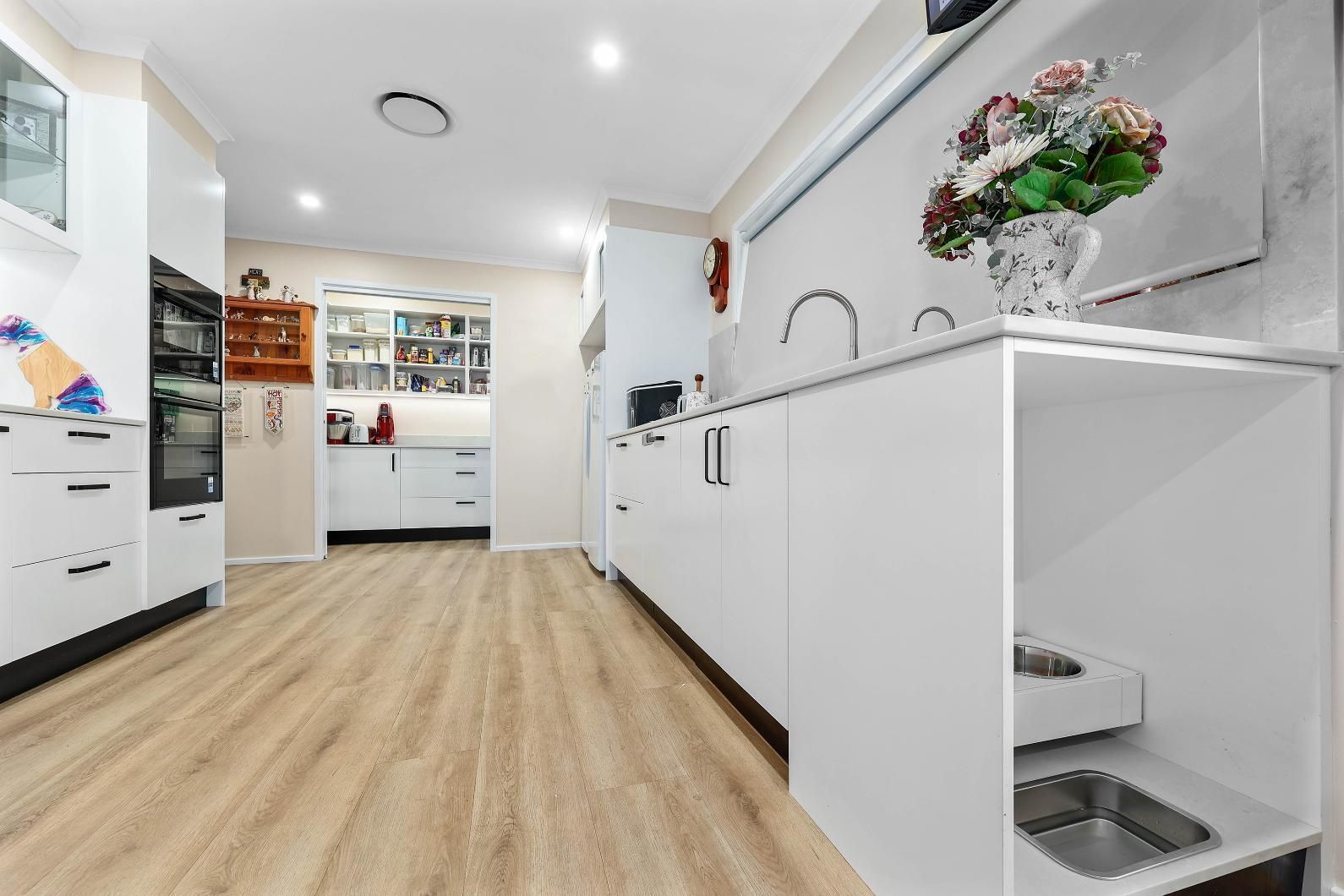 Bright Modern Kitchen With White Cabinets — Above & Beyond Interiors in Smeaton Grange, NSW