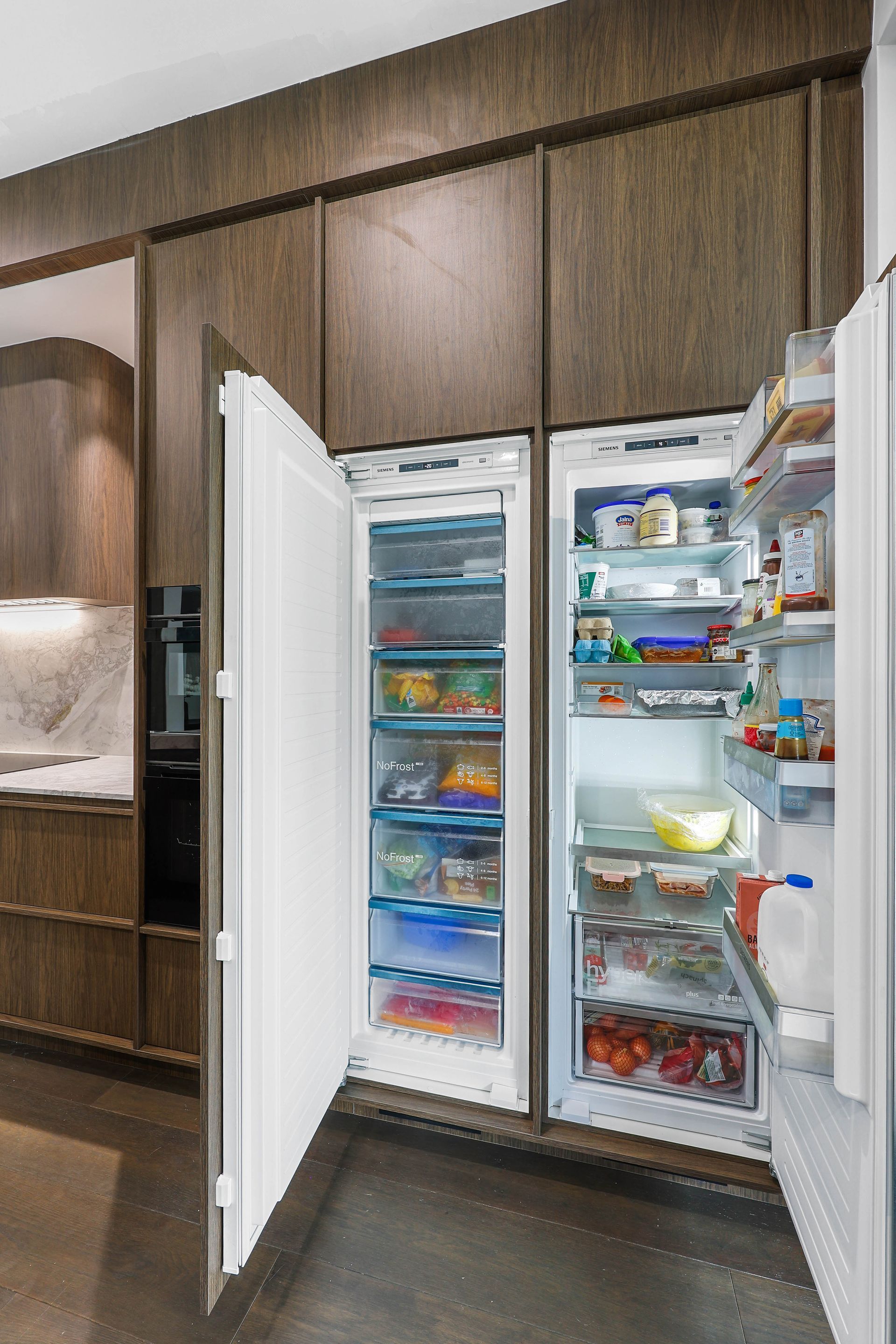 Open Refrigerator With White Shelves and Drawers Built — Above & Beyond Interiors in Smeaton Grange, NSW