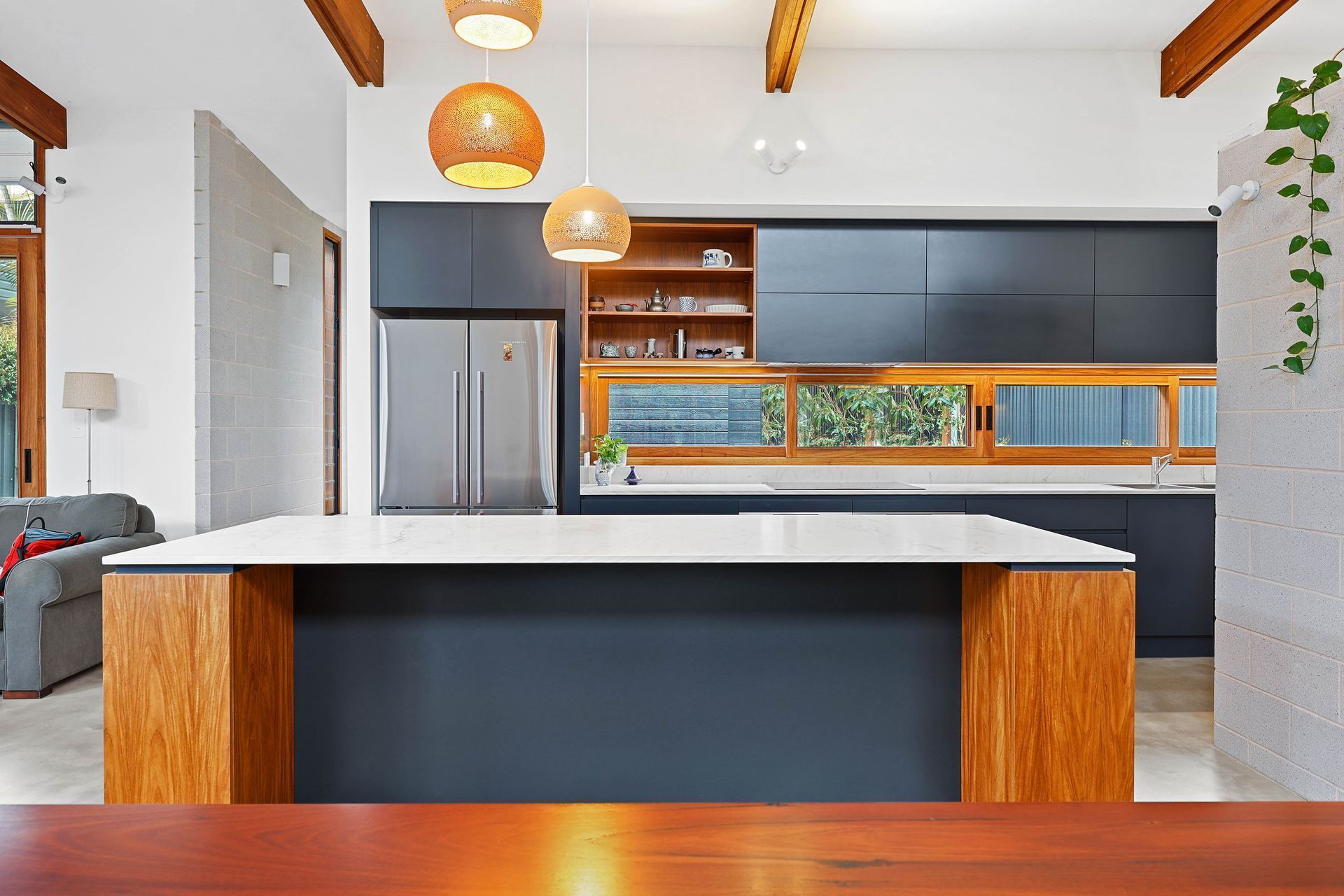 Modern Kitchen With White Island, Dark Cabinets — Above & Beyond Interiors in Smeaton Grange, NSW