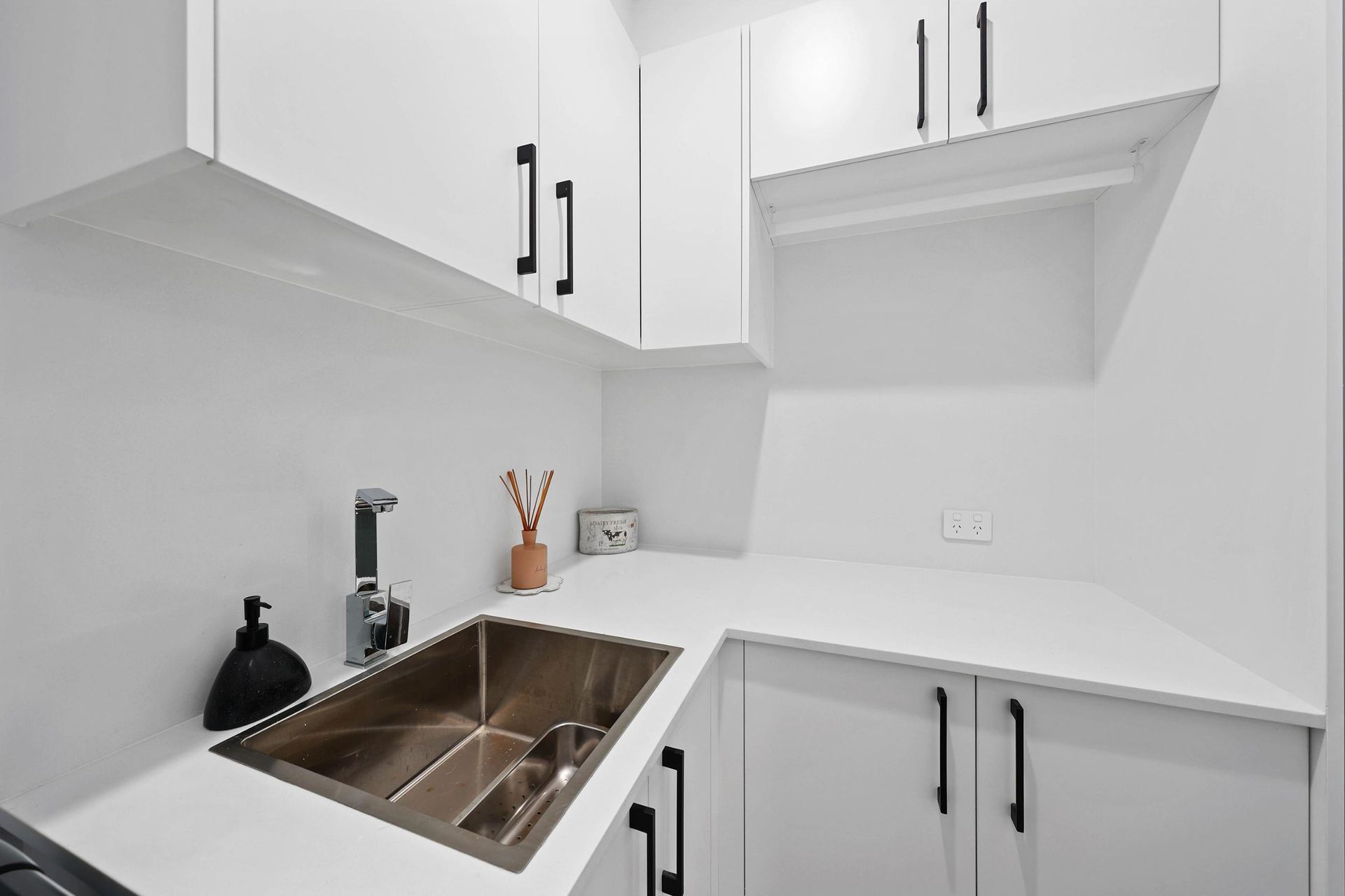 Bright White Kitchen Corner With White Cabinets — Above & Beyond Interiors in Smeaton Grange, NSW
