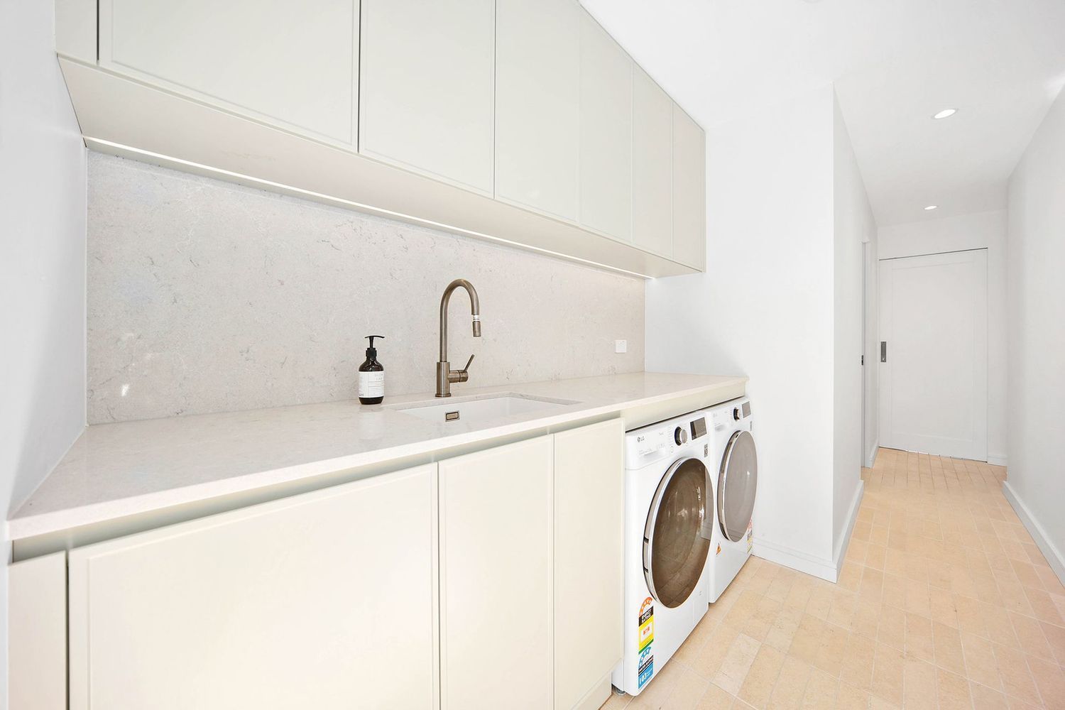 Bright White Laundry Room With Sink, Cabinets — Above & Beyond Interiors in Smeaton Grange, NSW