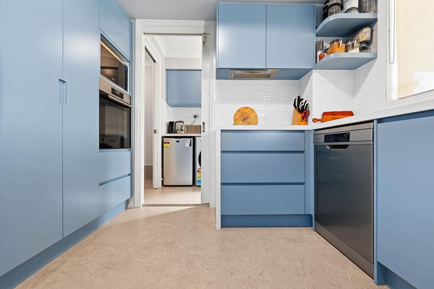 Blue Galley Kitchen With Built-in Appliances — Above & Beyond Interiors in Smeaton Grange, NSW