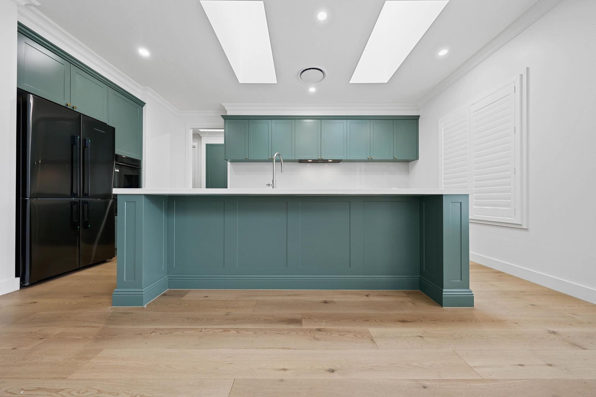Modern Kitchen With Teal Island, White Cabinetry — Above & Beyond Interiors in Smeaton Grange, NSW