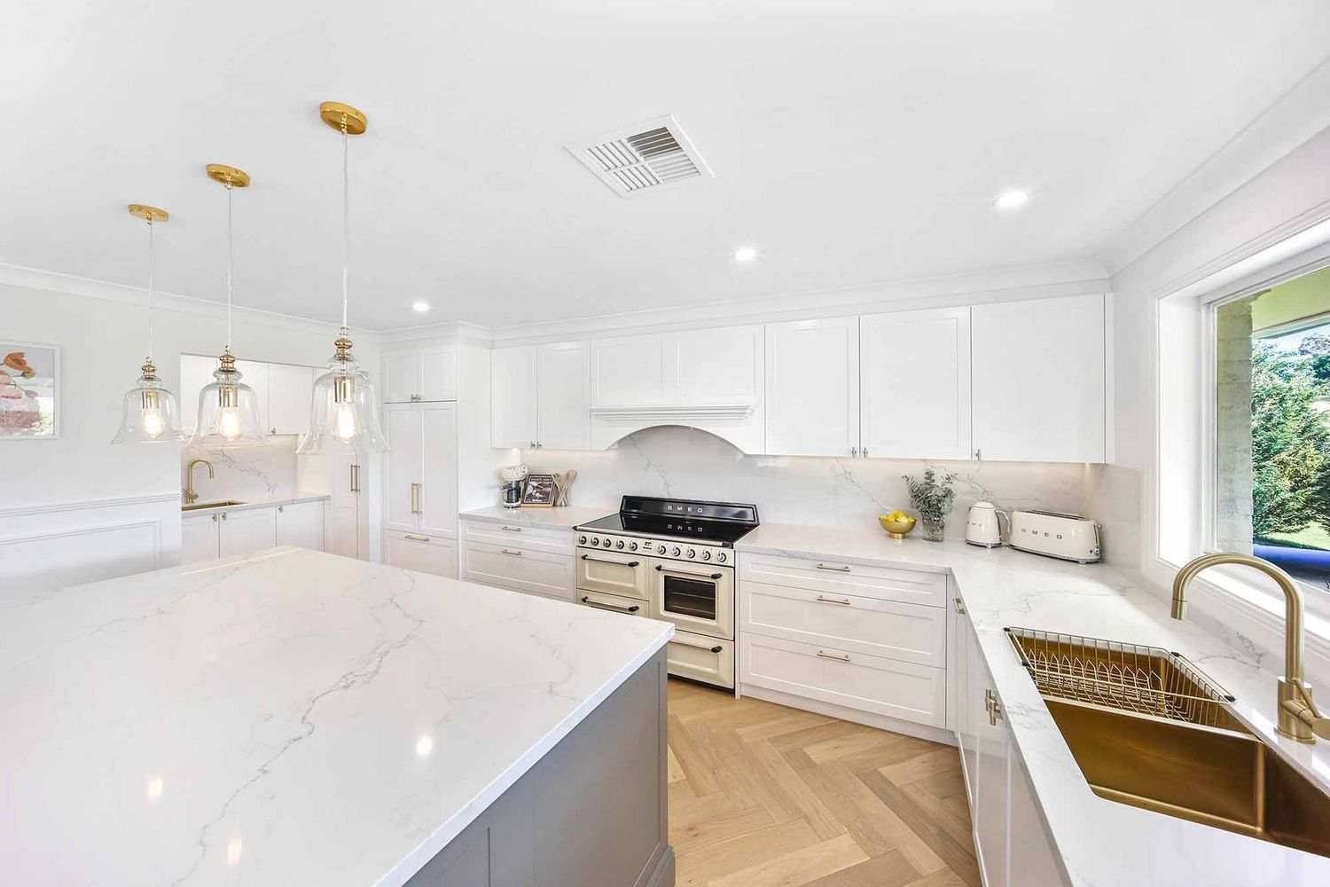 Bright White Modern Kitchen With Island, Stainless Stove — Above & Beyond Interiors in Smeaton Grange, NSW
