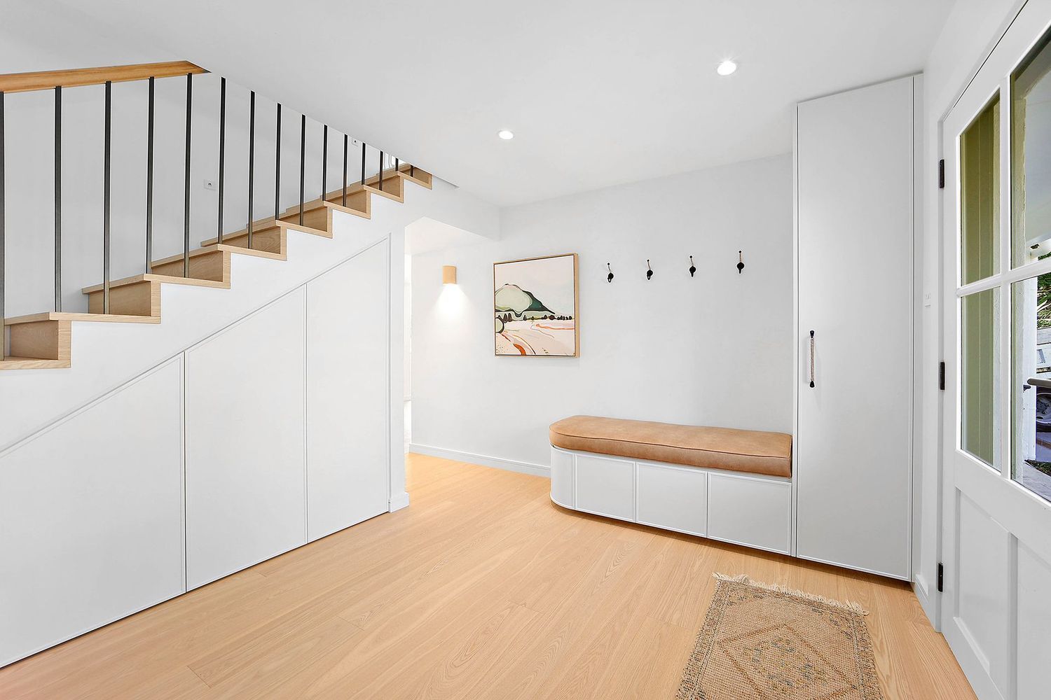 Bright Entry Hall With White Built-ins, Wooden Stairs — Above & Beyond Interiors in Smeaton Grange, NSW