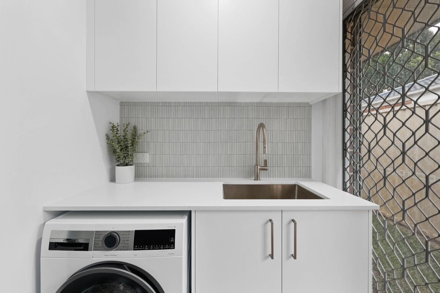 Compact Laundry Nook With Sink, White Cabinets — Above & Beyond Interiors in Smeaton Grange, NSW