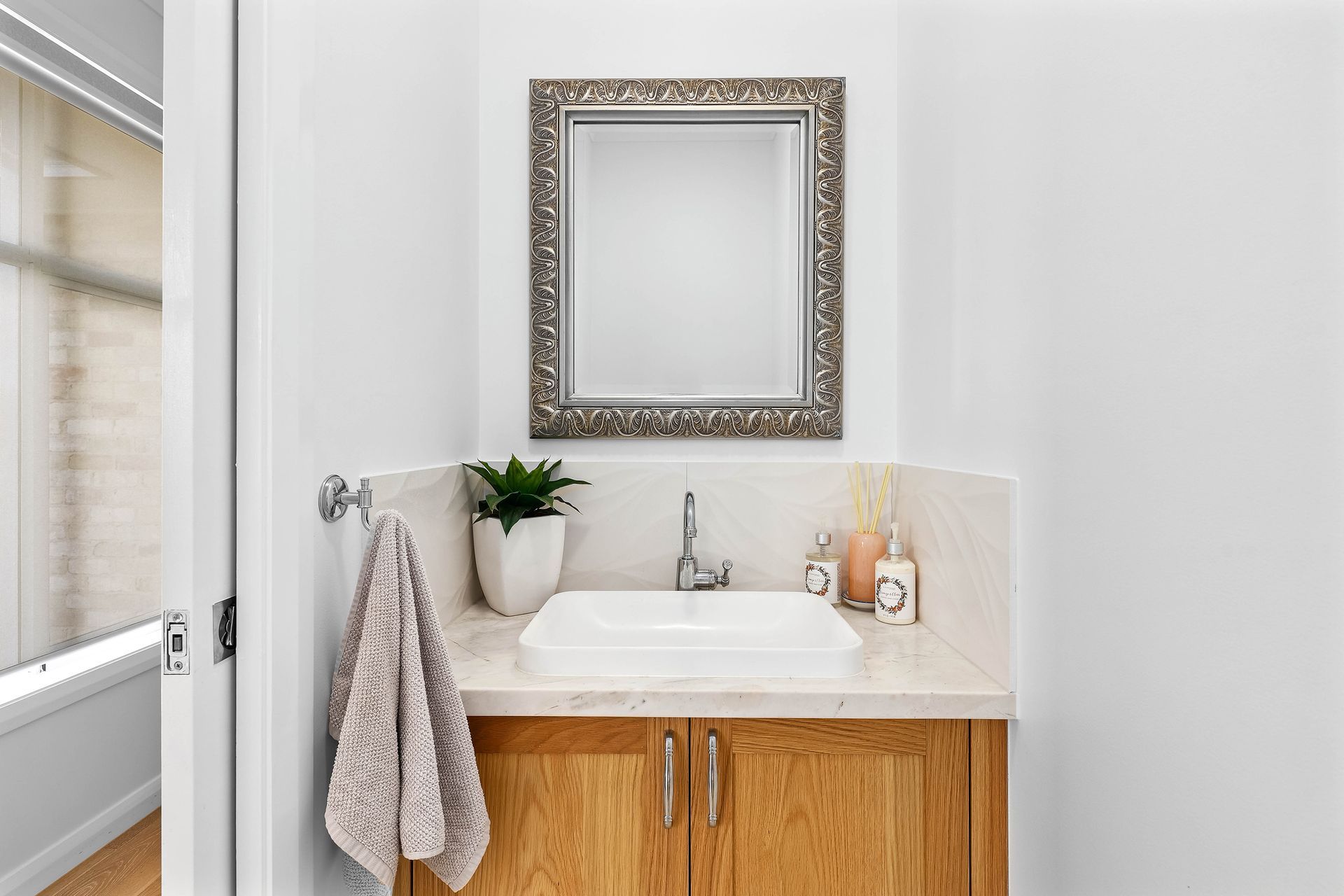 Small Bathroom Vanity With Sink, Ornate Mirror — Above & Beyond Interiors in Smeaton Grange, NSW