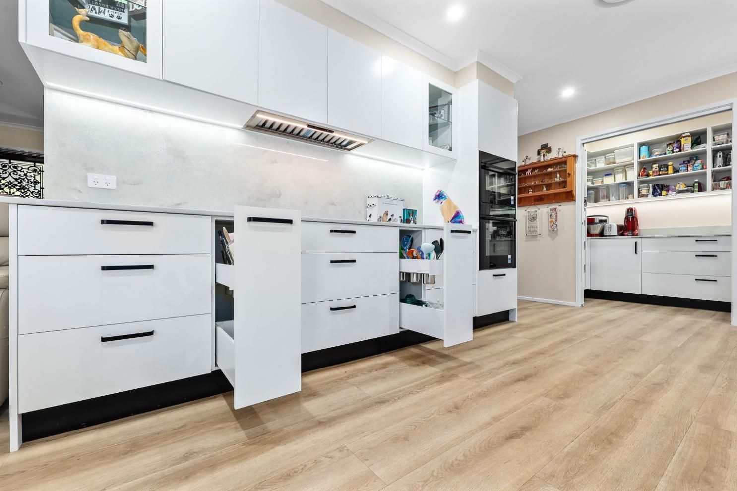 Bright Modern Kitchen With White Cabinets — Above & Beyond Interiors in Smeaton Grange, NSW