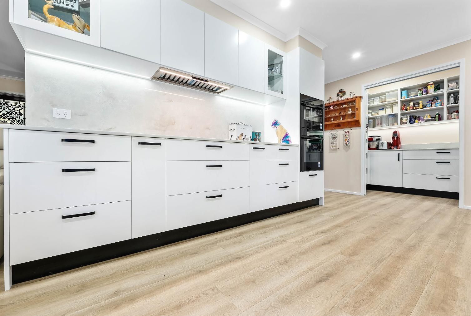 Bright Modern Kitchen With White Cabinets — Above & Beyond Interiors in Smeaton Grange, NSW