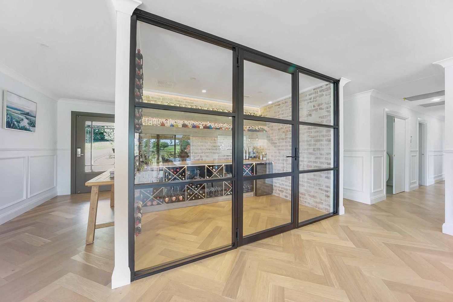 Black-framed Glass Partition in a Bright Herringbone-floored — Above & Beyond Interiors in Smeaton Grange, NSW