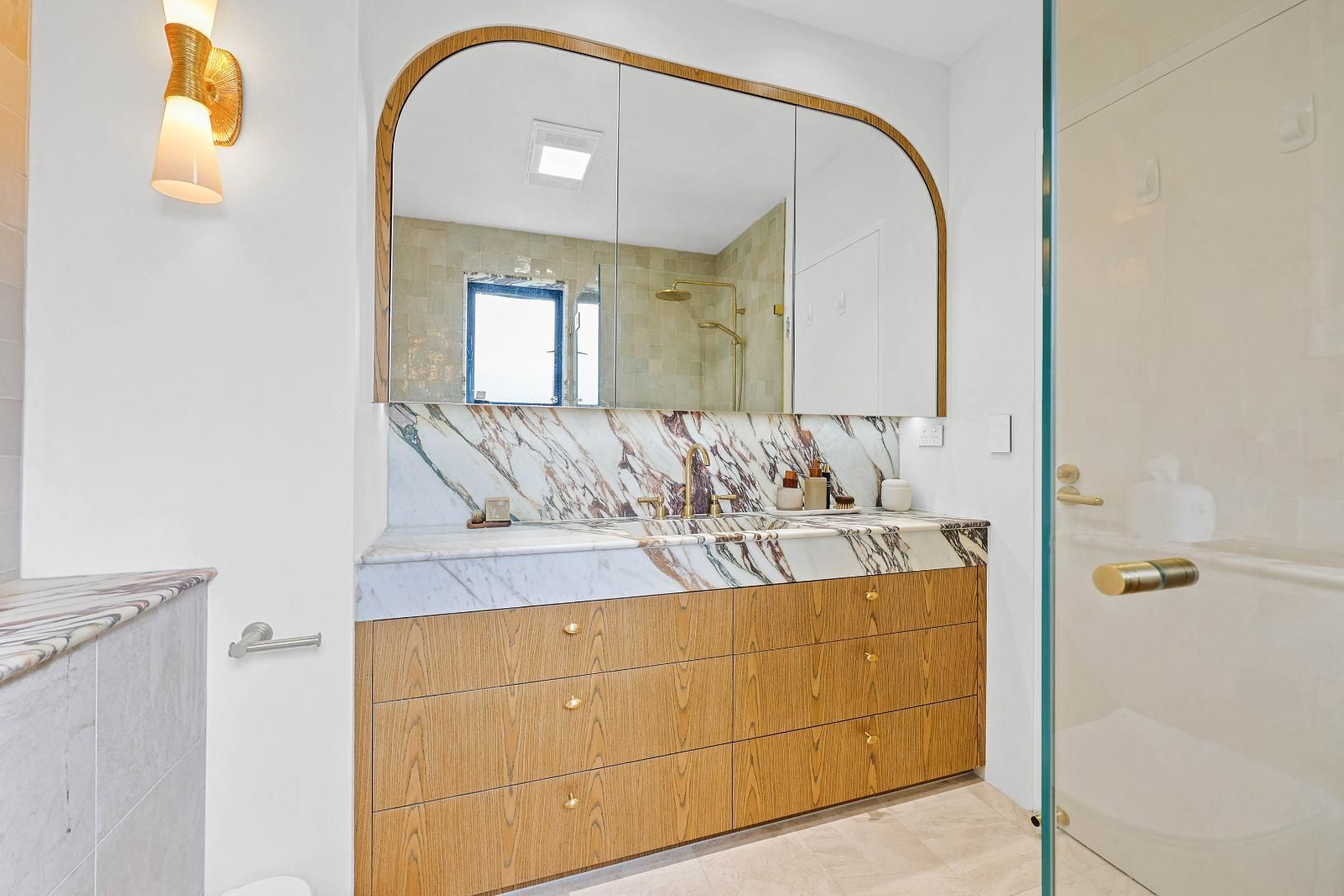Bright Bathroom Vanity With Wood Cabinets — Above & Beyond Interiors in Smeaton Grange, NSW