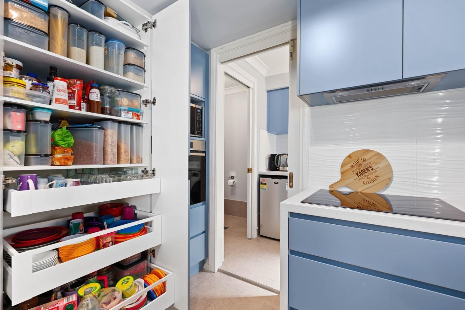 Open Pantry With Shelves of Groceries Beside — Above & Beyond Interiors in Smeaton Grange, NSW