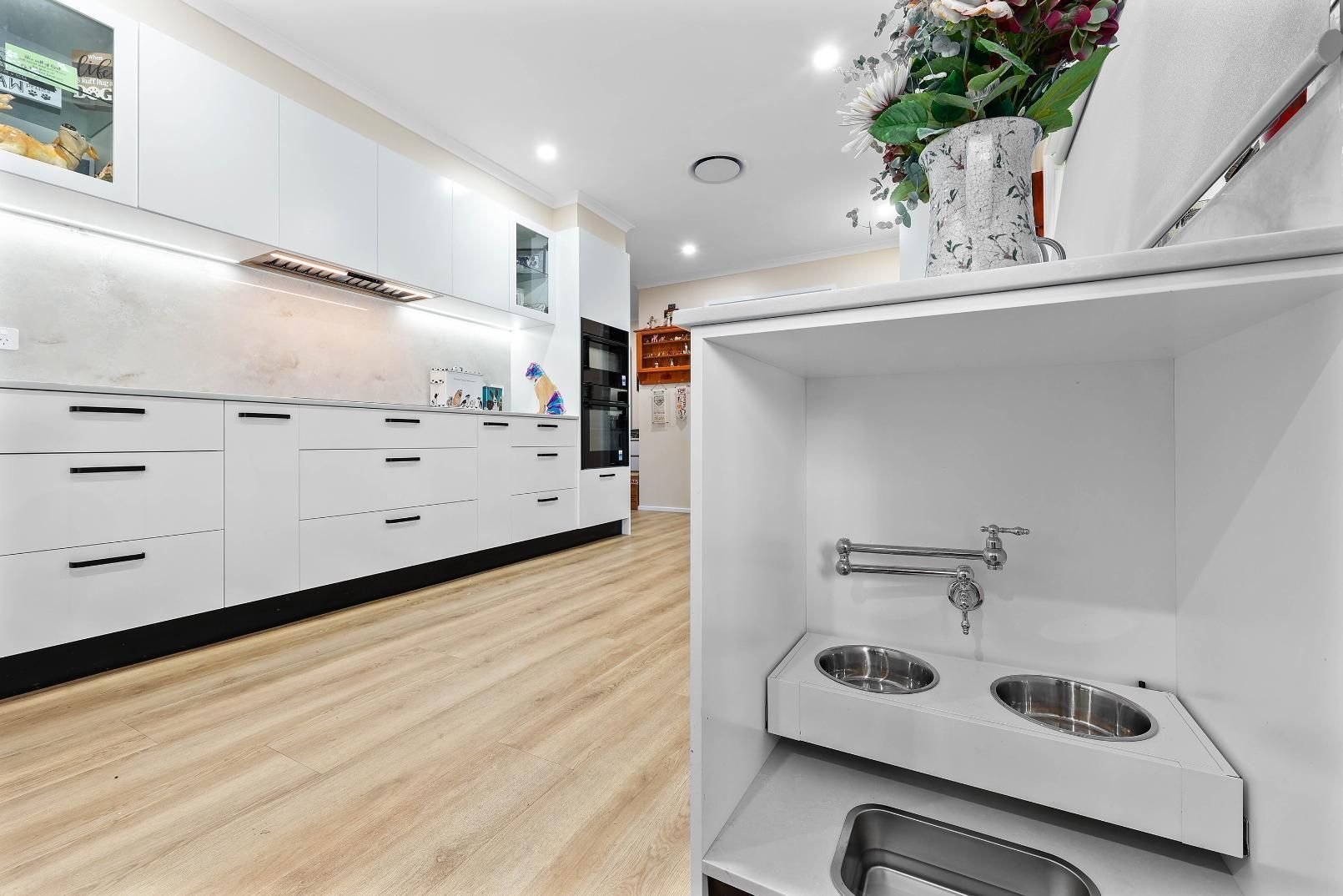 Modern Kitchen With White Cabinets, Wood Floors — Above & Beyond Interiors in Smeaton Grange, NSW