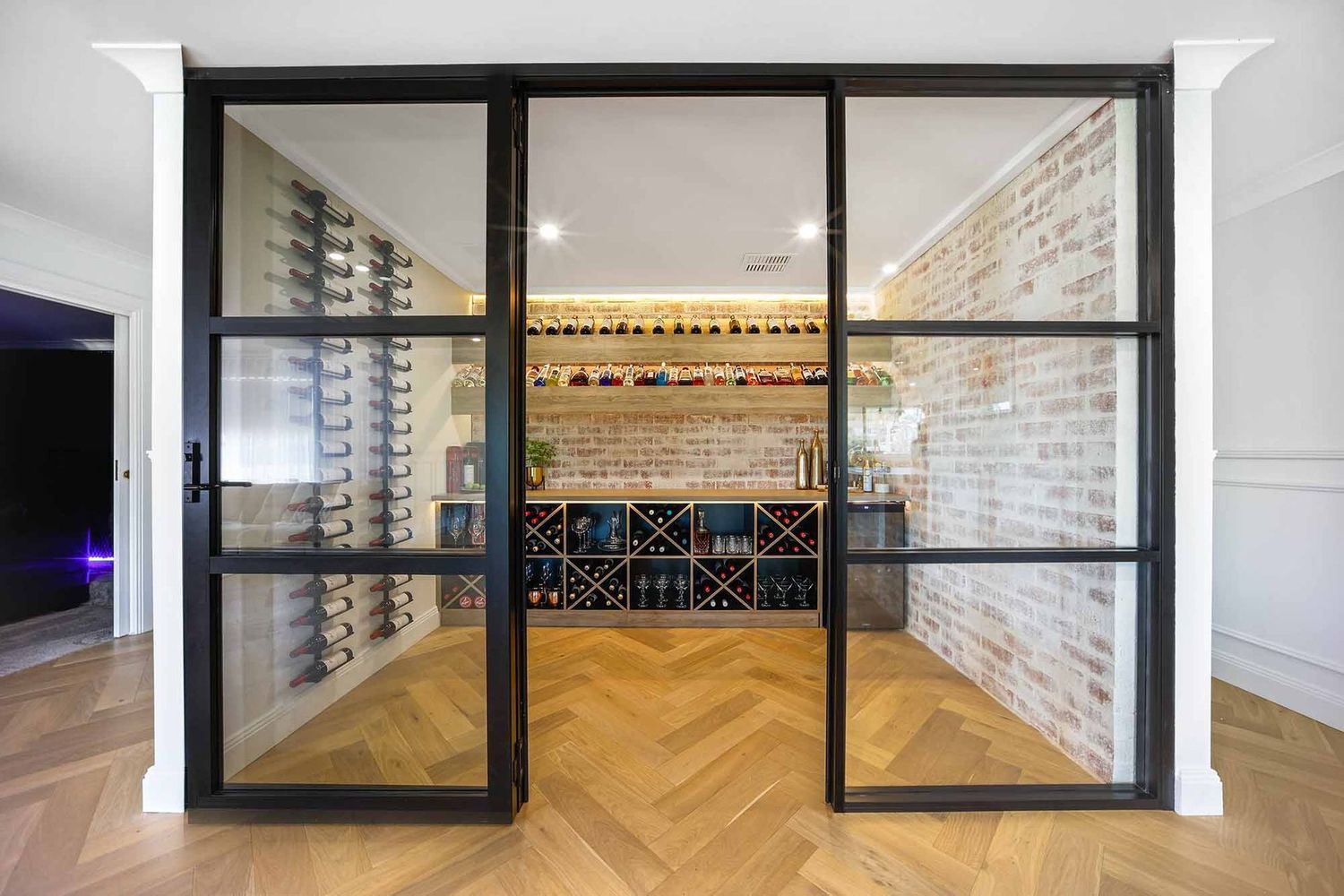 Glass-front Wine Room With Black-framed Doors — Above & Beyond Interiors in Smeaton Grange, NSW