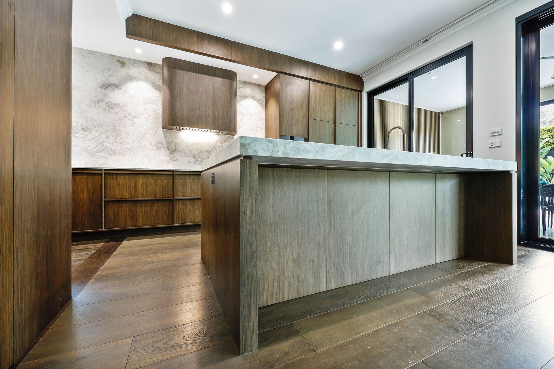 Modern Kitchen With Wood Cabinets, Large Island — Above & Beyond Interiors in Smeaton Grange, NSW