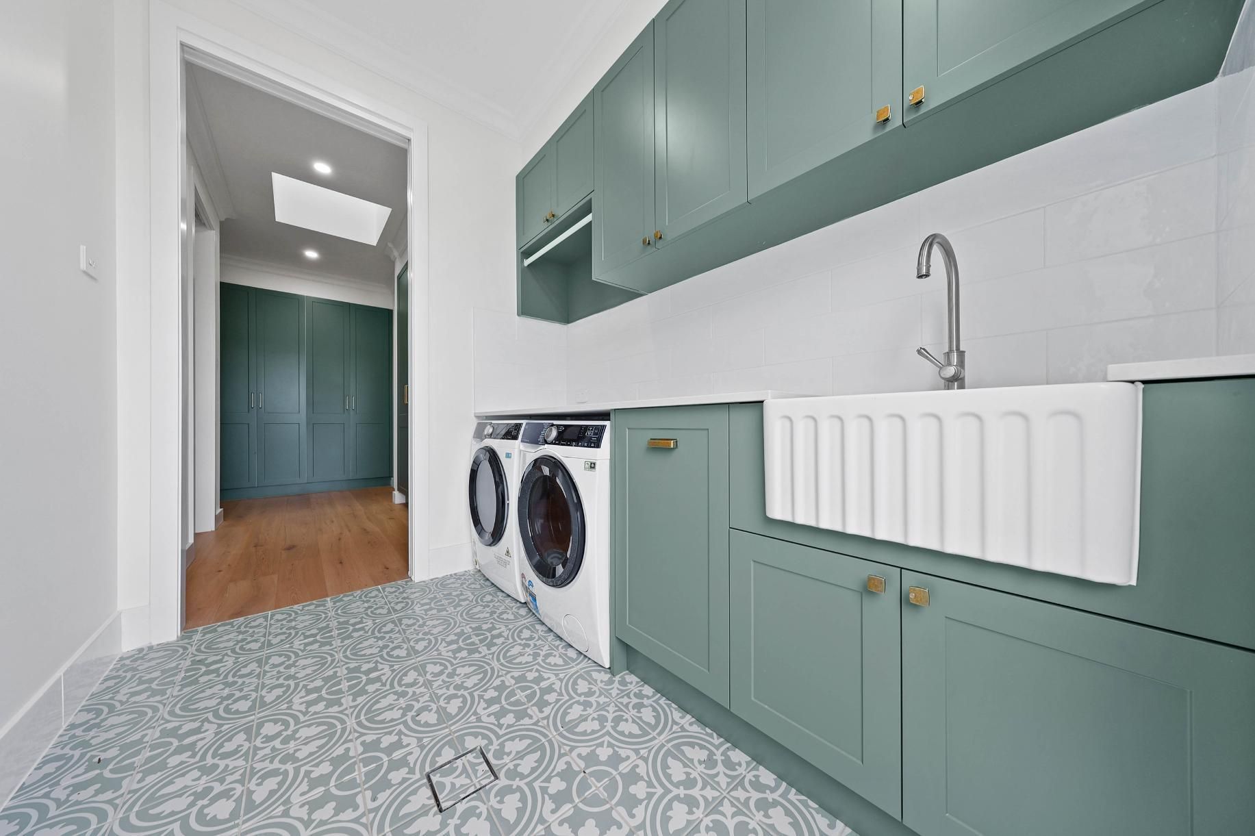 Modern Laundry Room With Sage Cabinets, Patterned Floor — Above & Beyond Interiors in Smeaton Grange, NSW